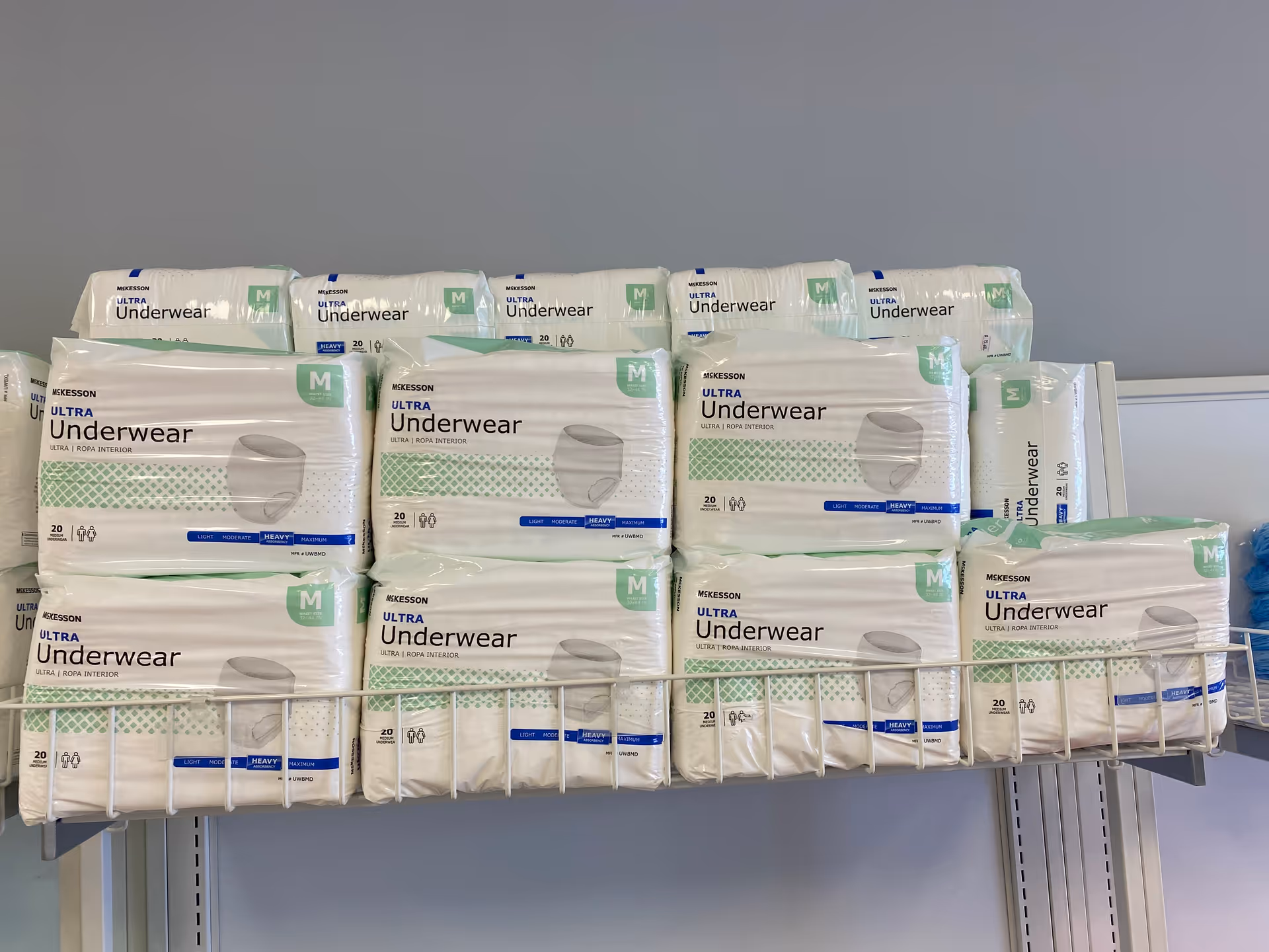 Stacks of Ultra Underwear packages on a metal wire shelf.