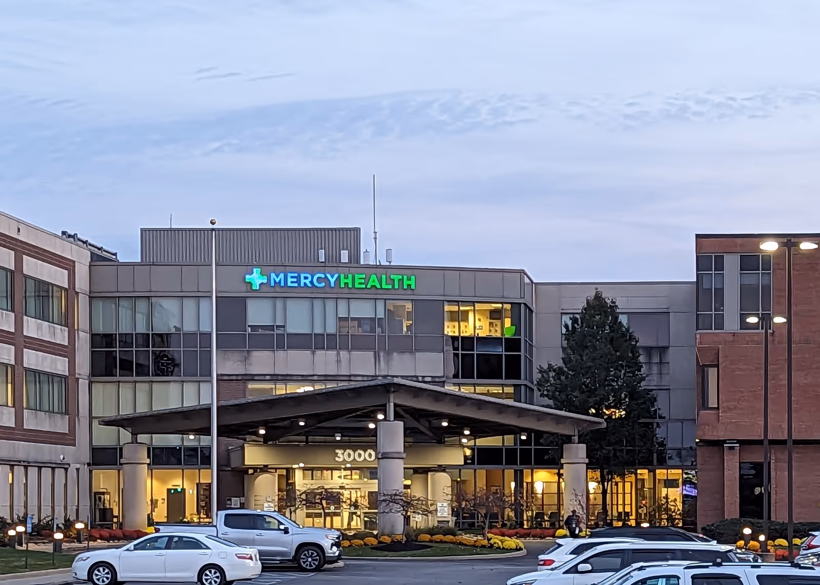 Front view of Mercy Health Clermont Hospital entrance with parked cars