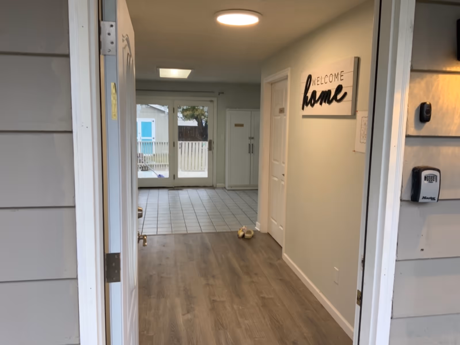 Interior hallway of a senior living facility with a Welcome home sign at the entrance.