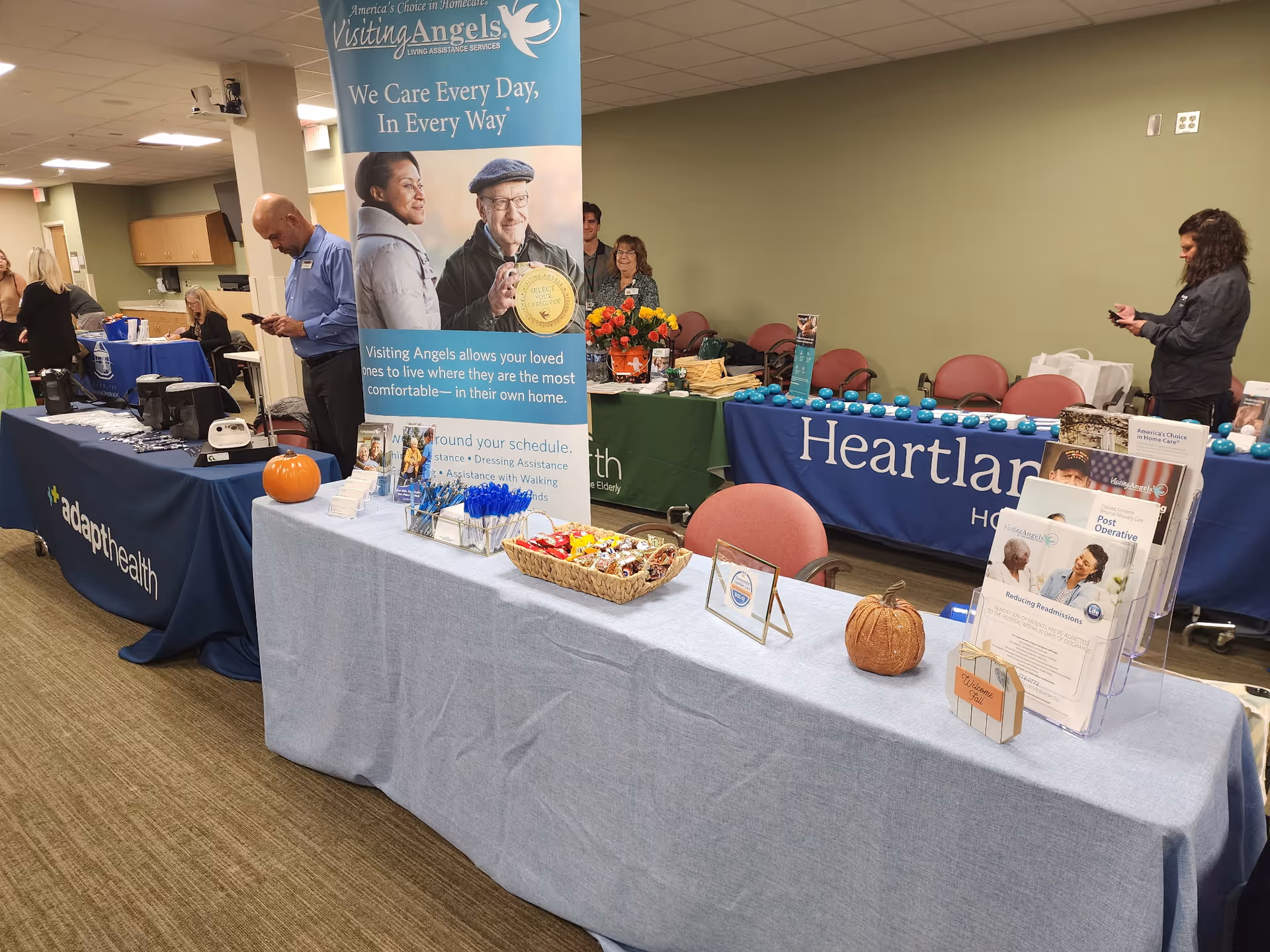 Indoor event with booths and banners for Visiting Angels Senior Home Care Traverse City.