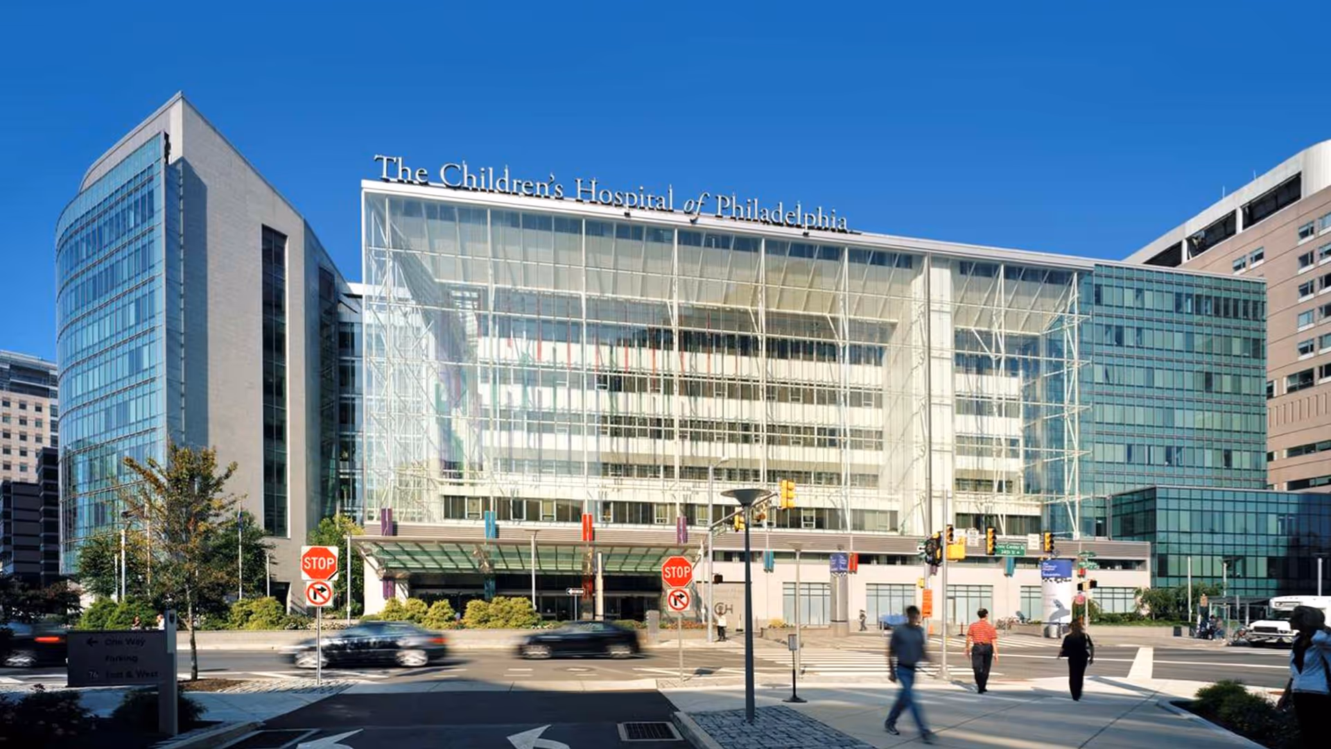 Front facade of The Children's Hospital of Philadelphia with glass exterior and pedestrians.