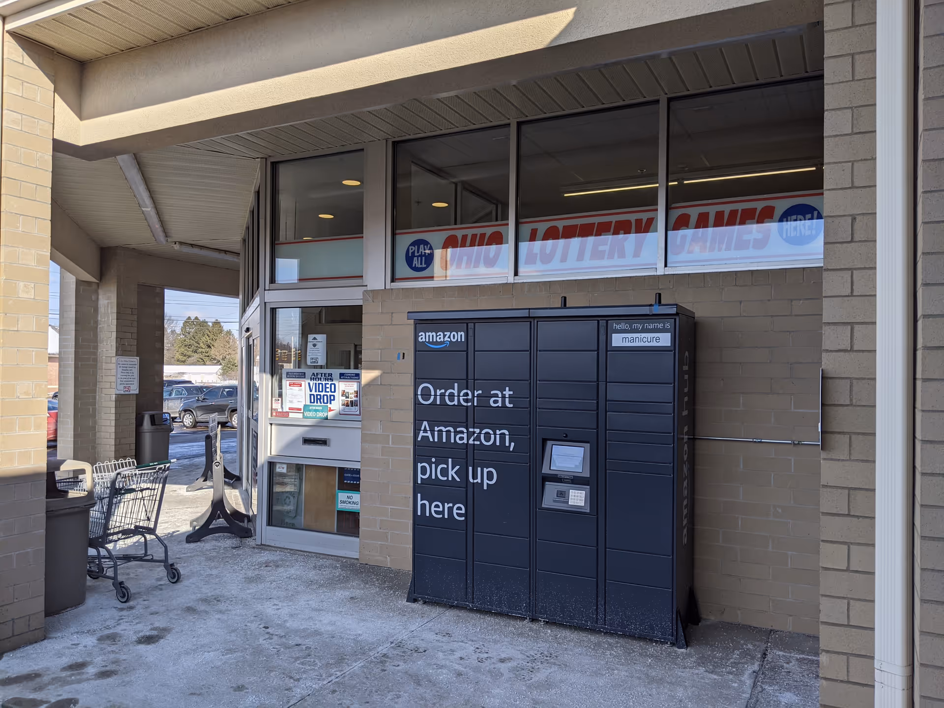 Exterior front of Discount Drug Mart storefront with carts and a vending locker.