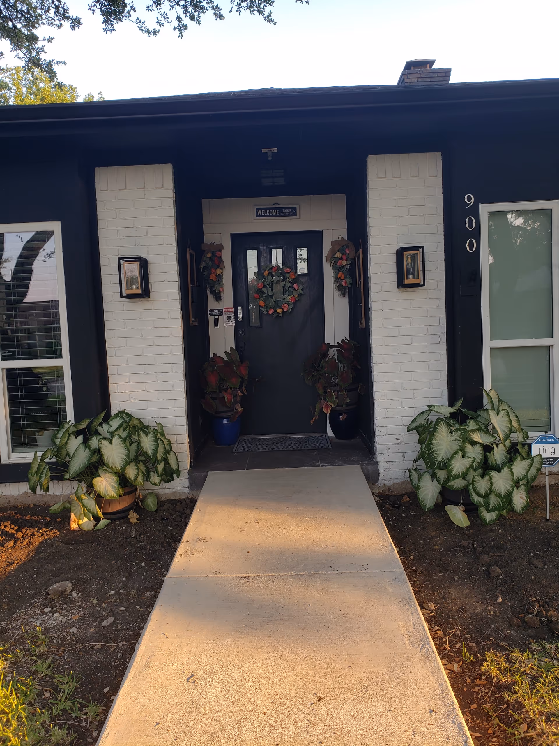 Front entrance of Integrity Residential Care LLC with wreaths, potted plants, and a walkway.