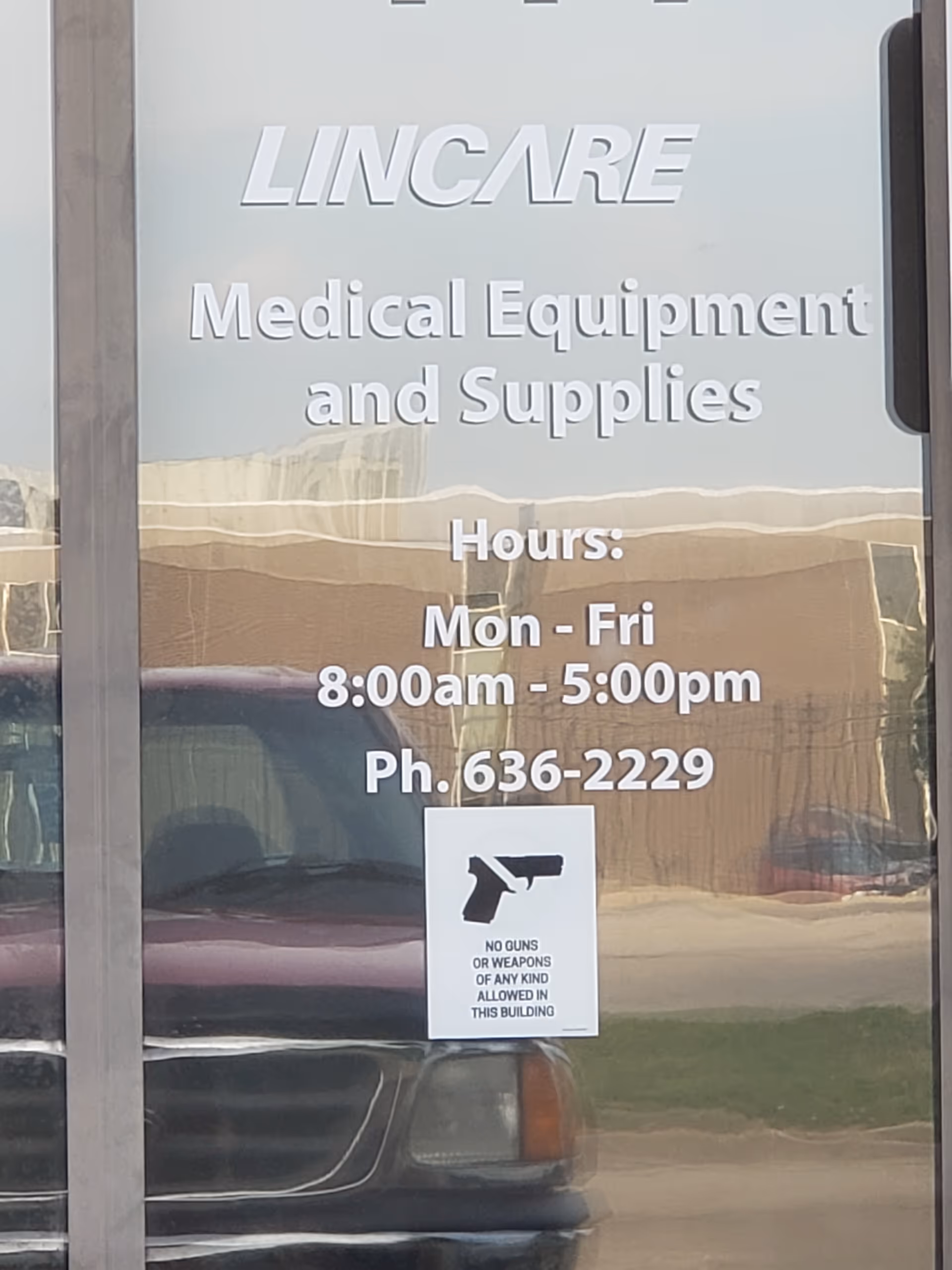 Front glass storefront signage reads LINCARE Medical Equipment and Supplies with hours and a no-guns sign
