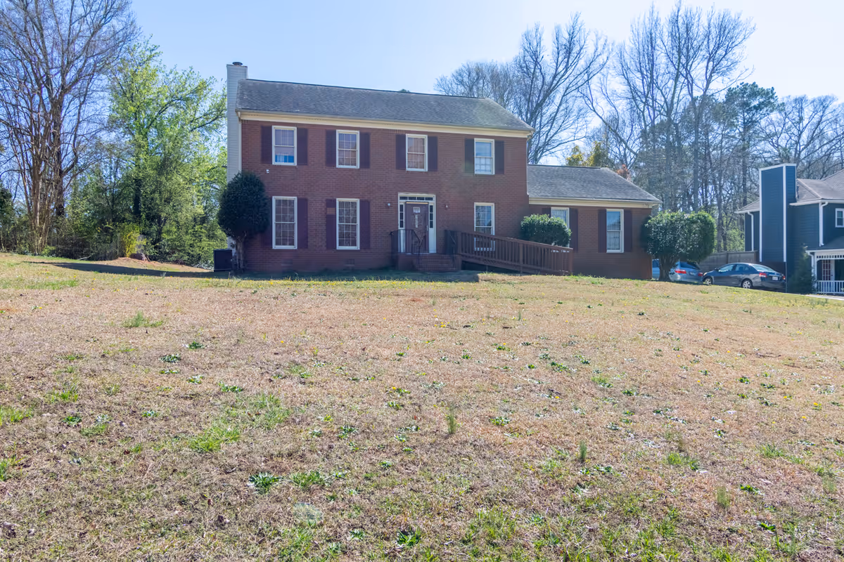 Brick senior living facility with a front porch and ramped entrance