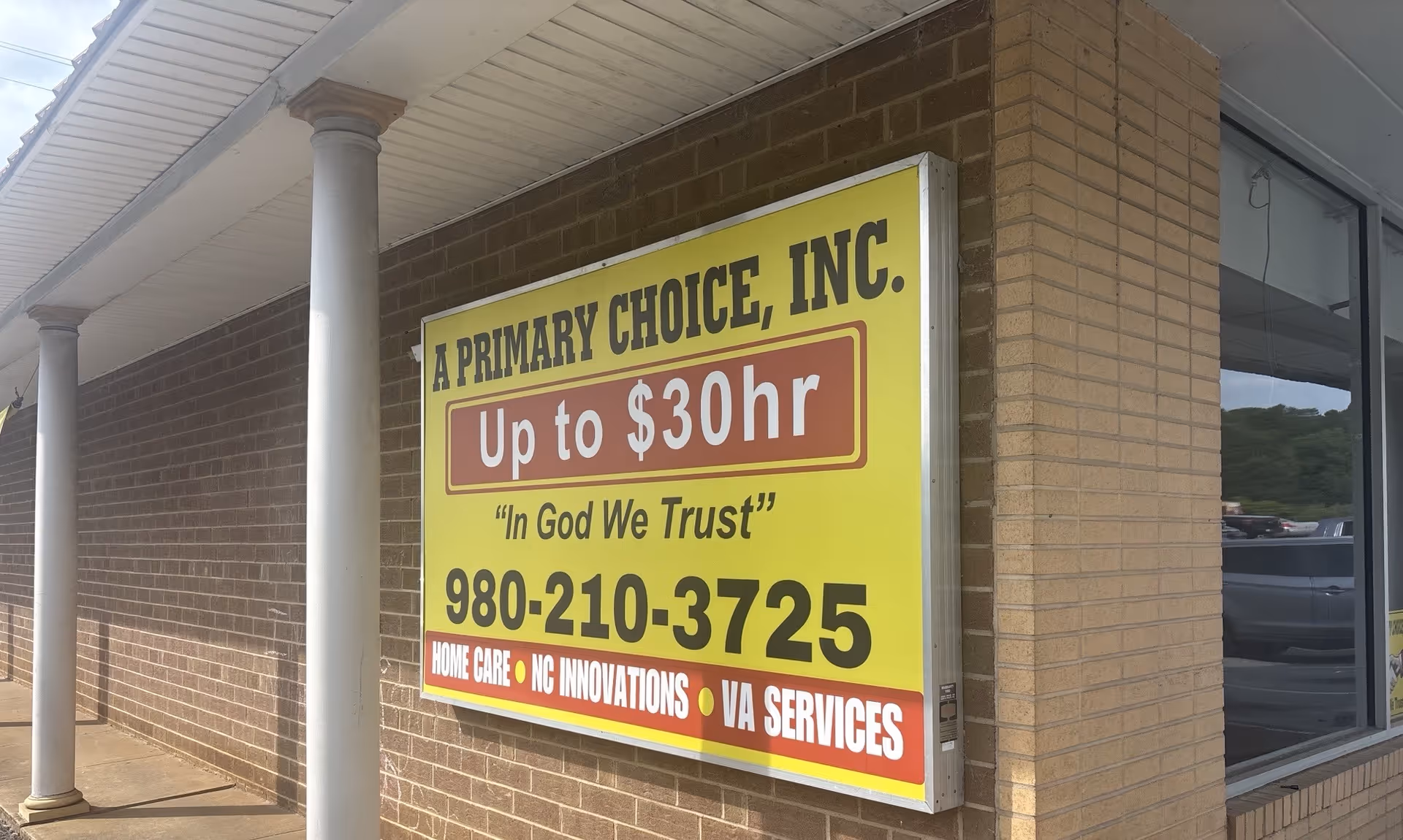 Exterior brick building with a large yellow sign for Primary Choice, Inc.