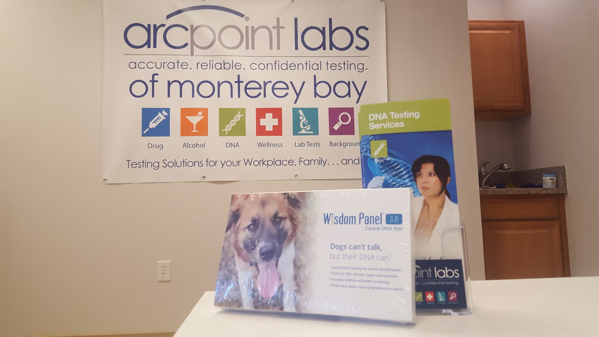 Interior space with arcpoint labs banner, DNA testing posters, and a dog image display.
