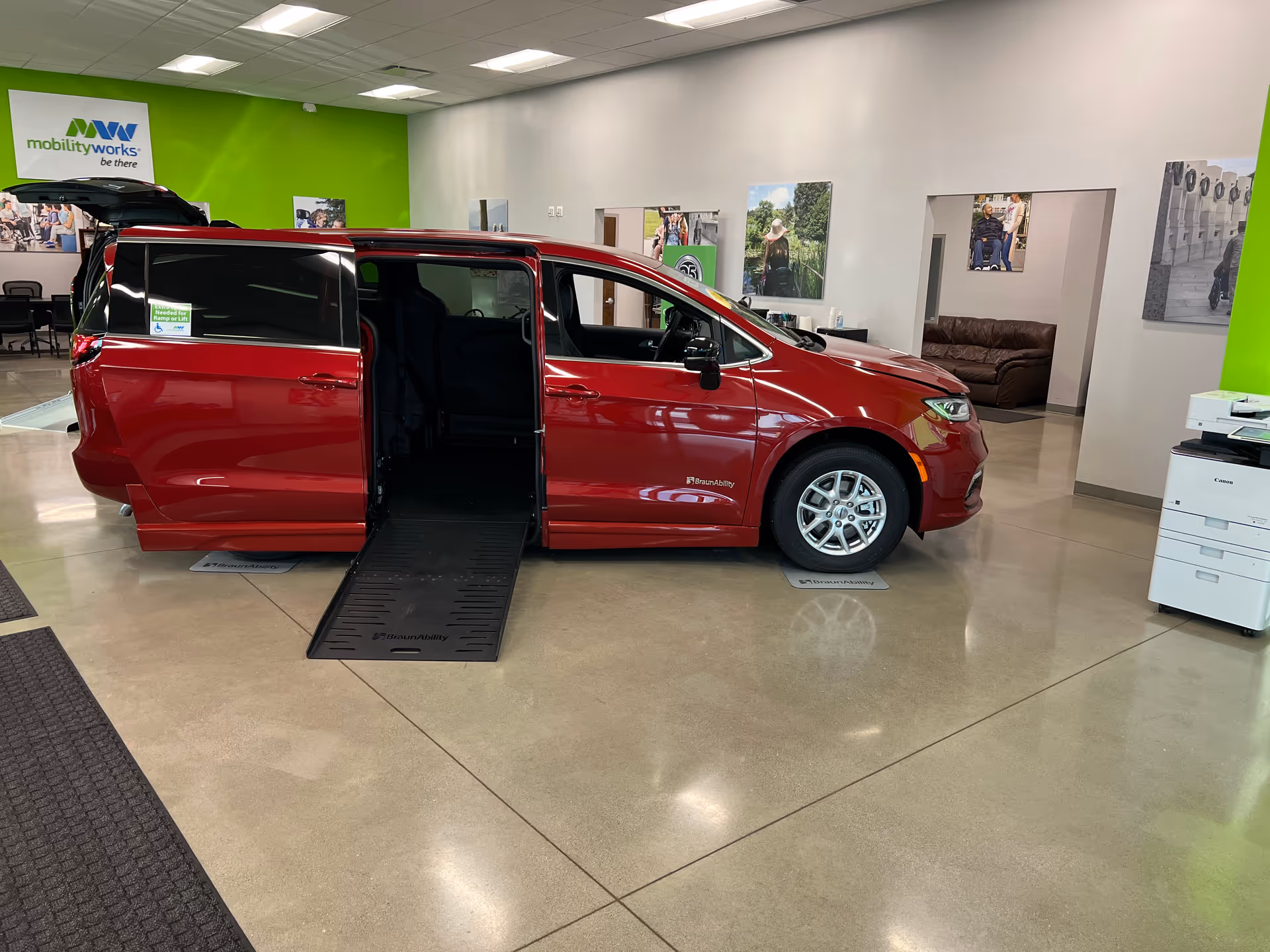 Red wheelchair-accessible van on display inside MobilityWorks showroom