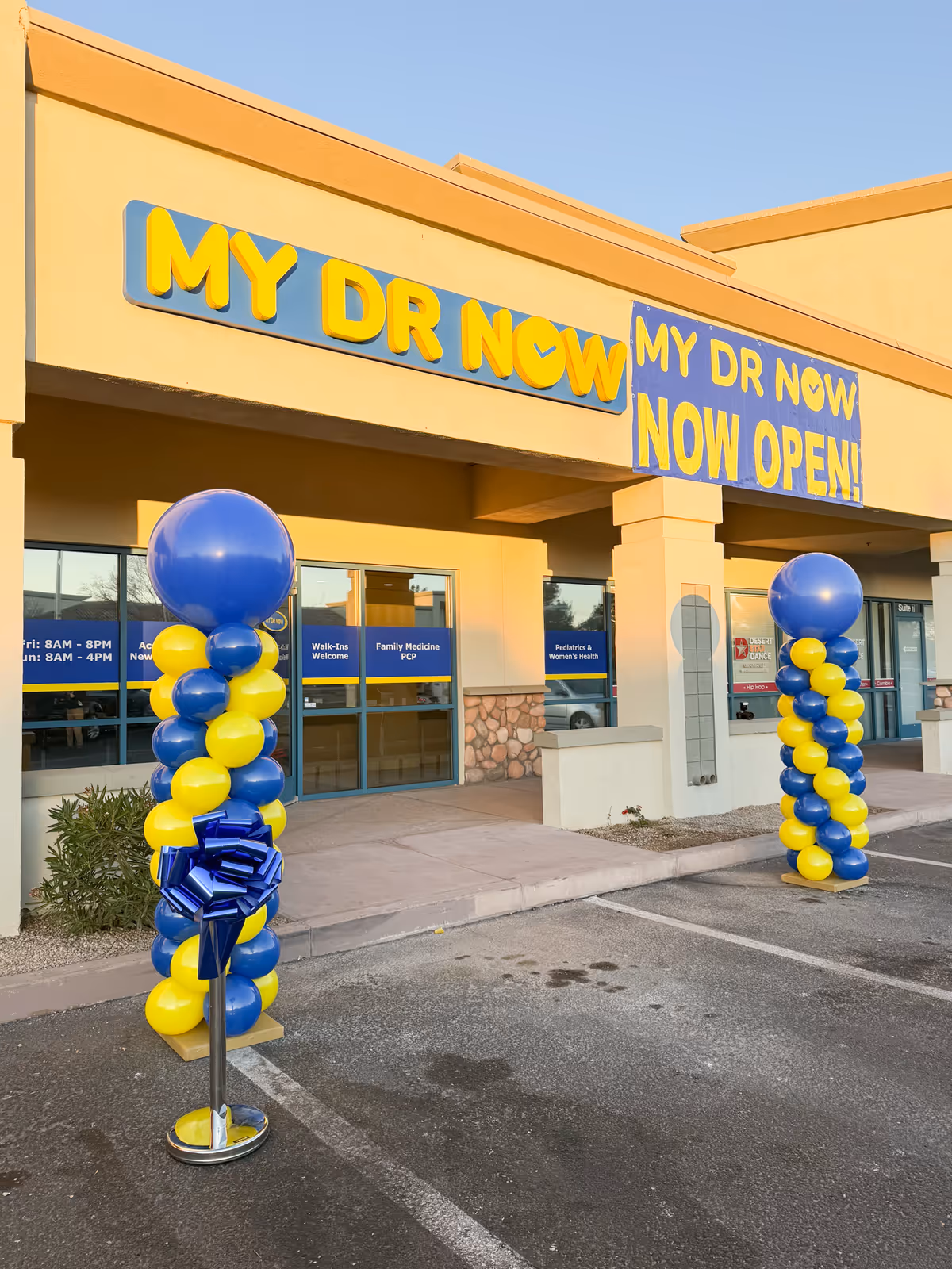 MY DR NOW facility front entrance with blue and yellow balloons and signage.