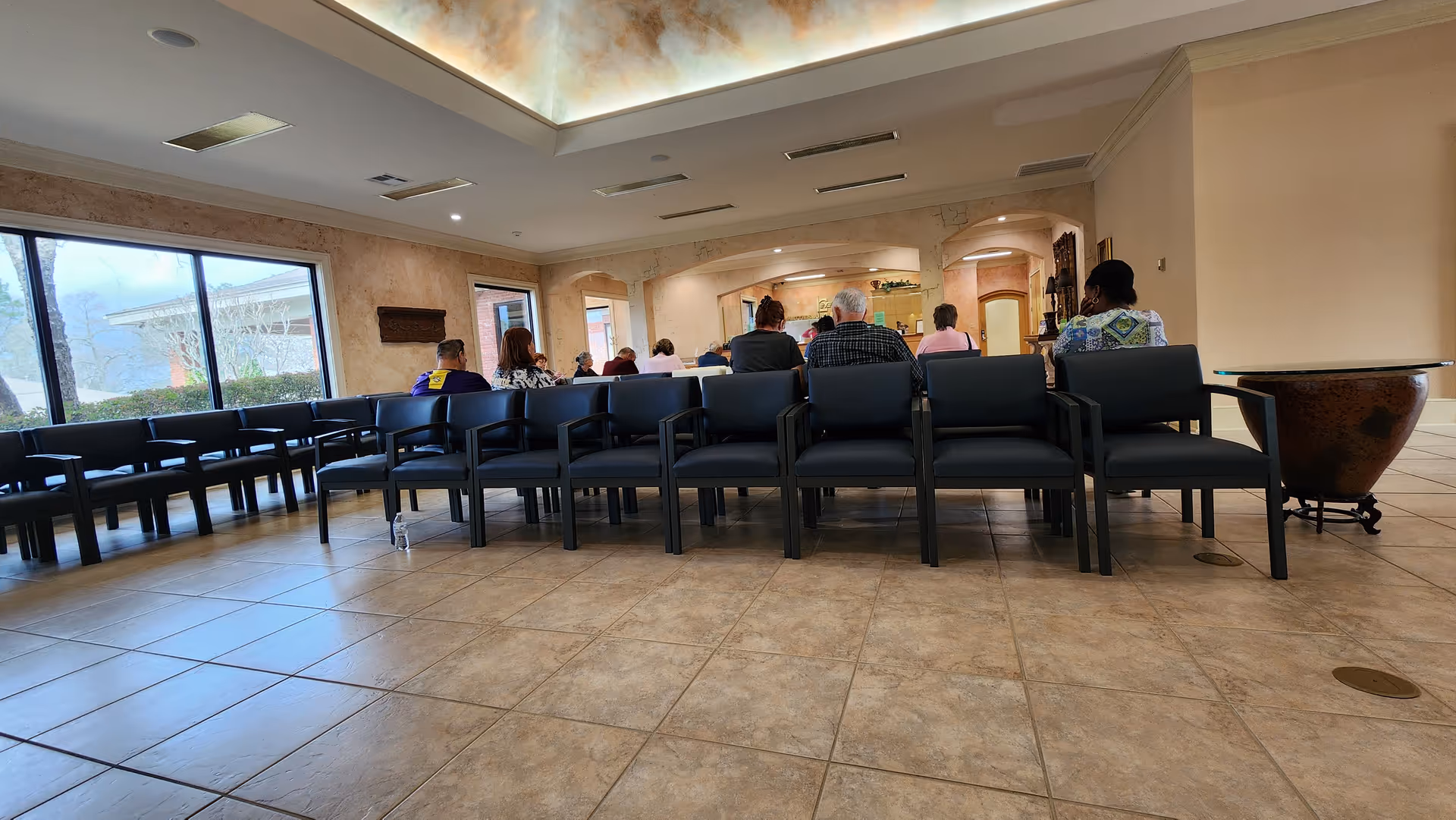Hattiesburg Eye Clinic waiting area with rows of chairs and patients seated.