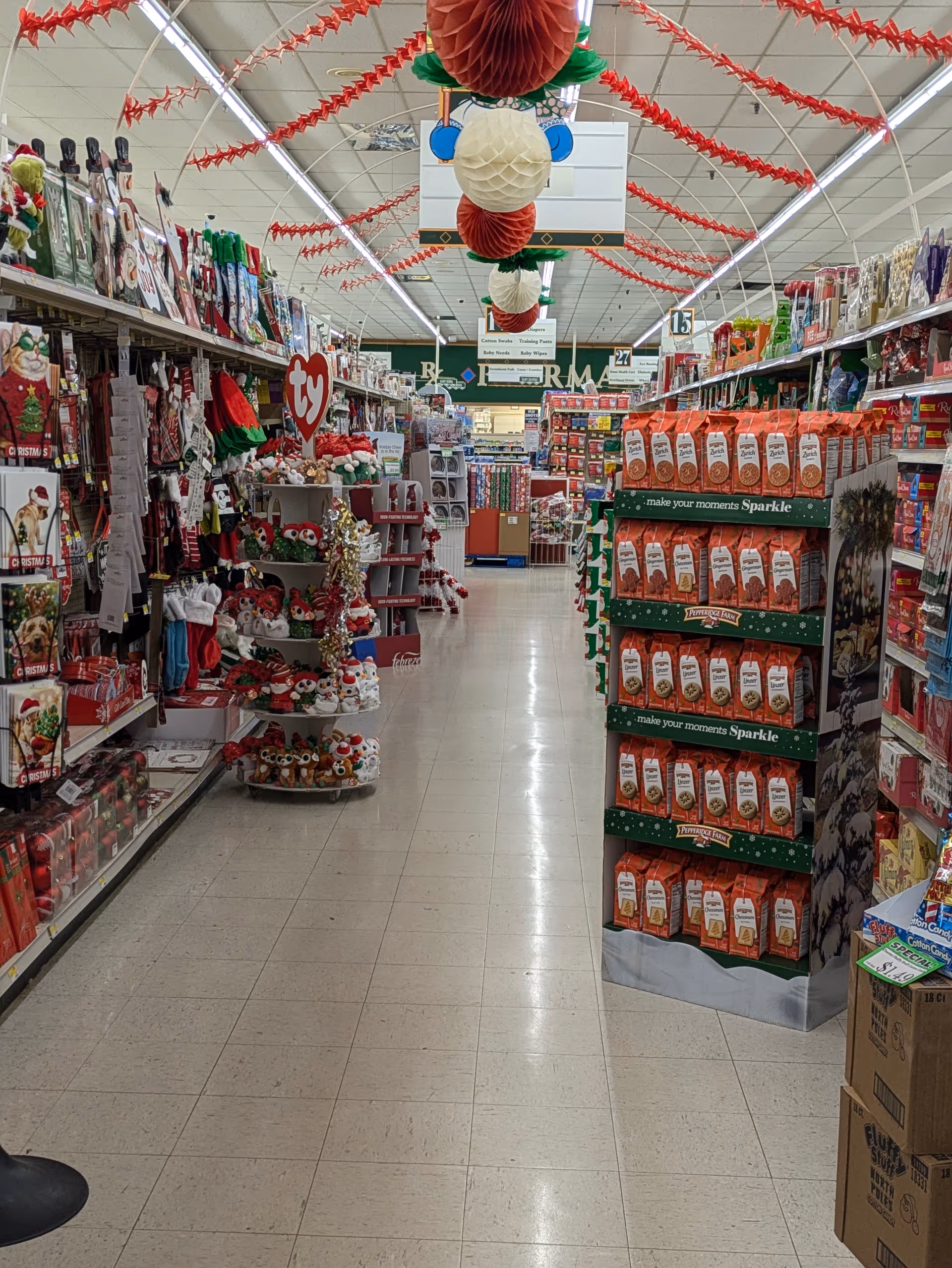Brightly lit Discount Drug Mart aisle with holiday decorations and product displays.