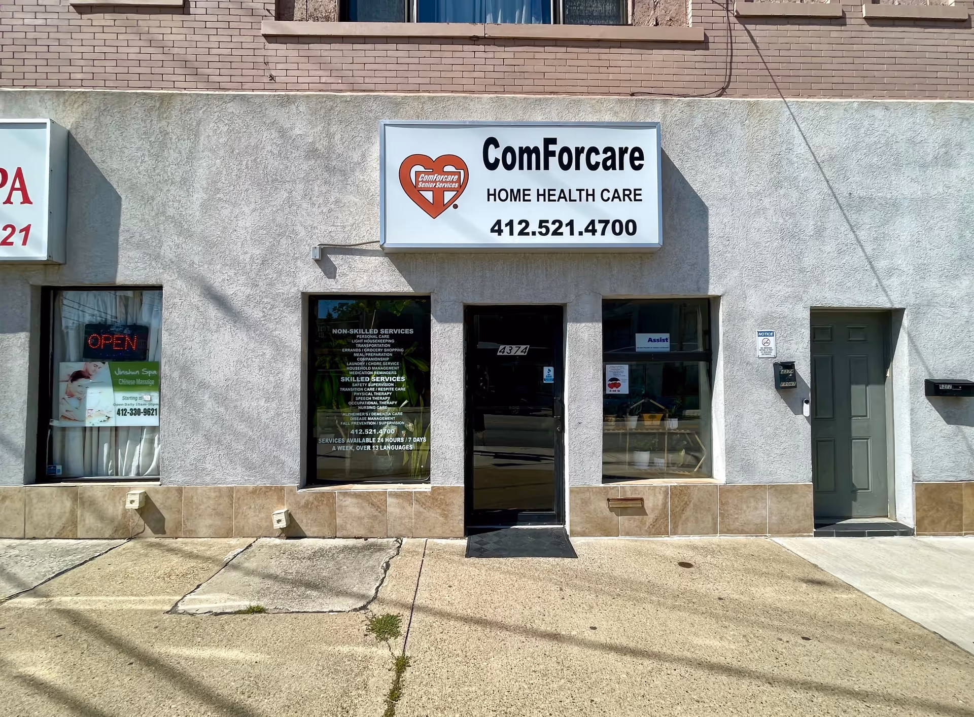 Front of a ComForCare Home Health Care storefront with sign and entrance