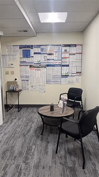 Interior waiting area in a senior care facility with bulletin board