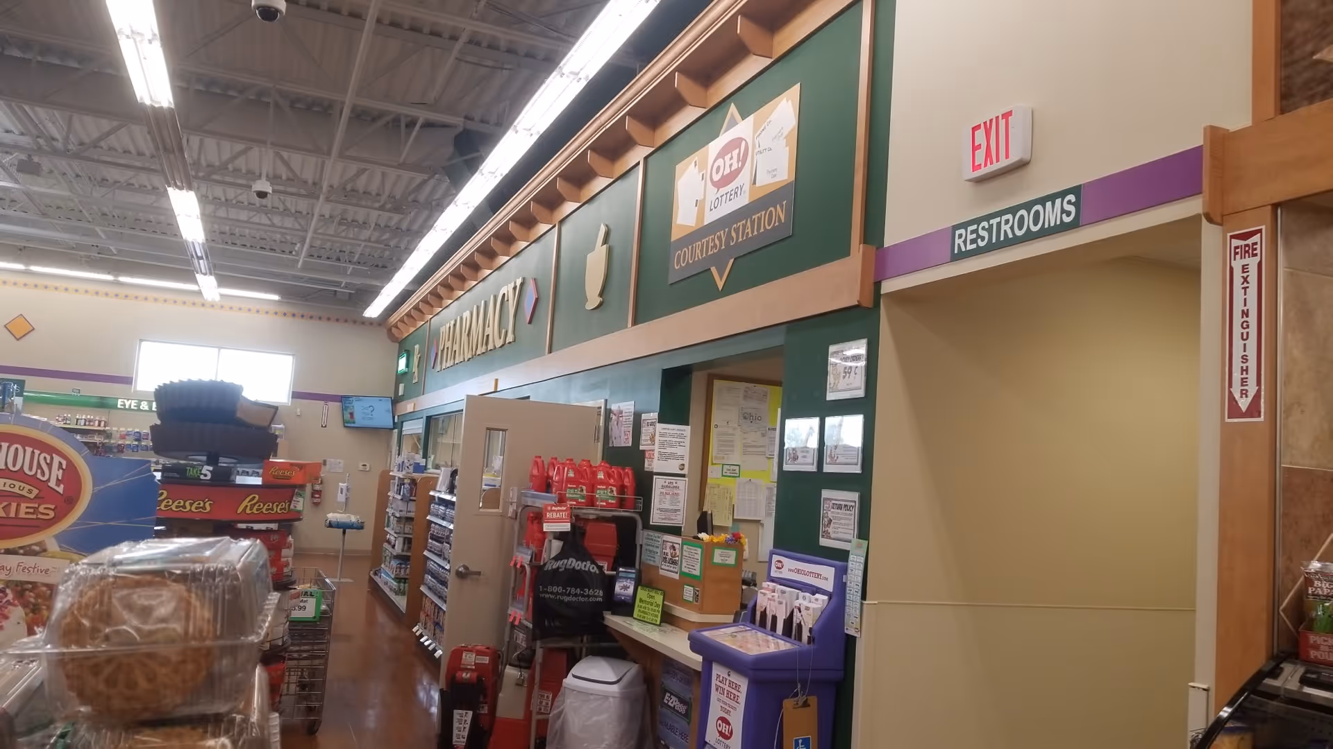 Interior of a Discount Drug Mart with pharmacy counter, signage, and aisles.