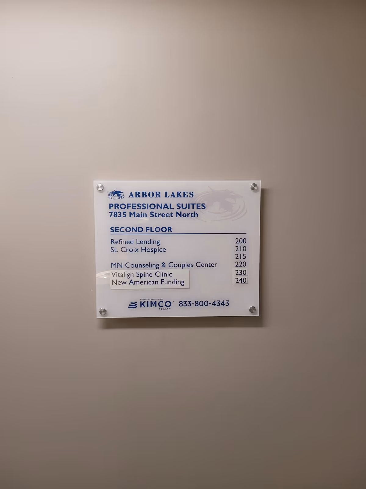 A wall-mounted directory plaque listing offices on the second floor.
