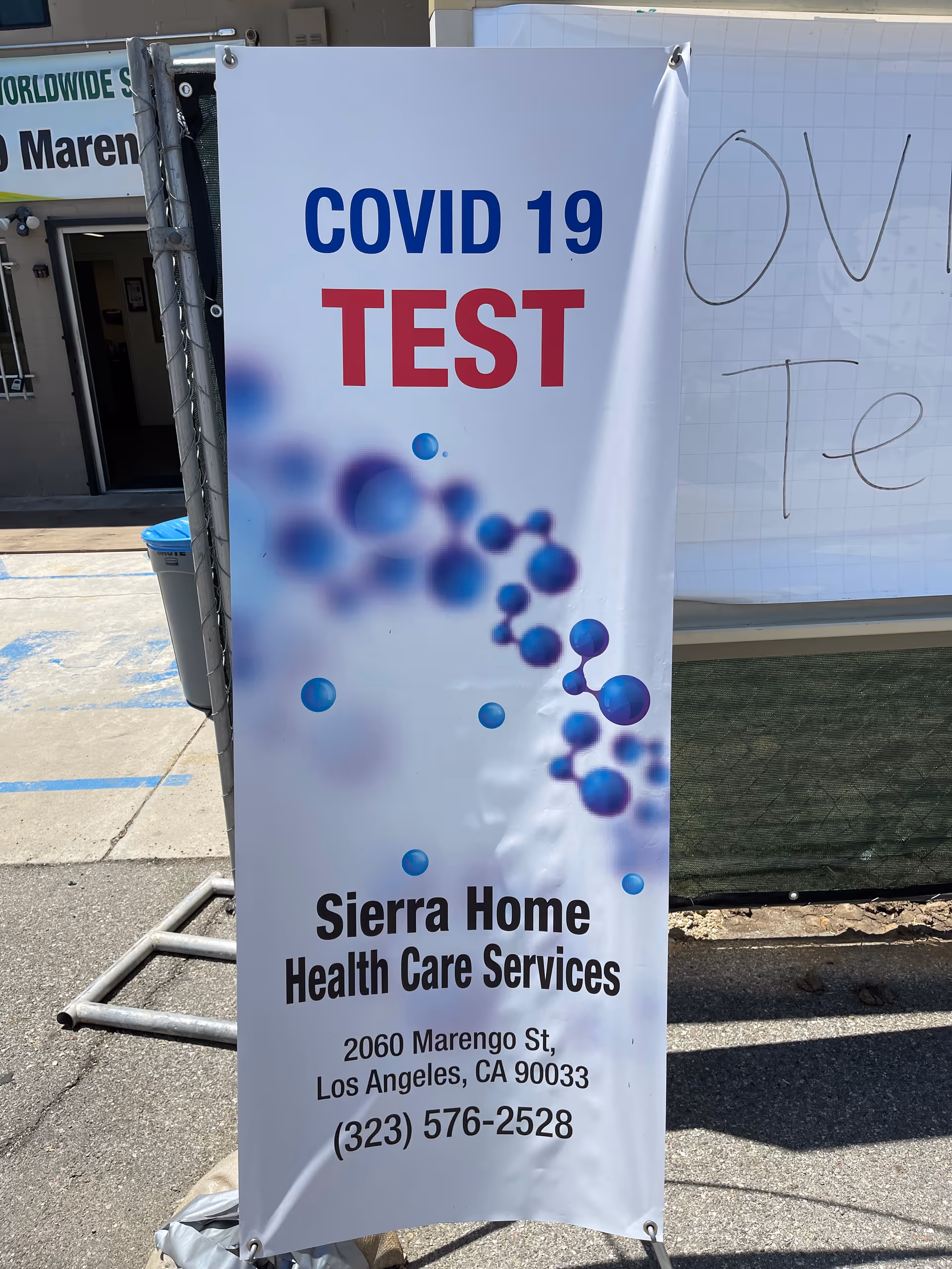 Outdoor banner advertising COVID-19 test for Sierra Home Health Care Services.