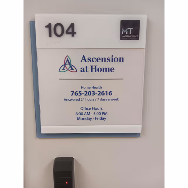 Wall-mounted sign for Ascension at Home, room number 104, with a keypad beneath.