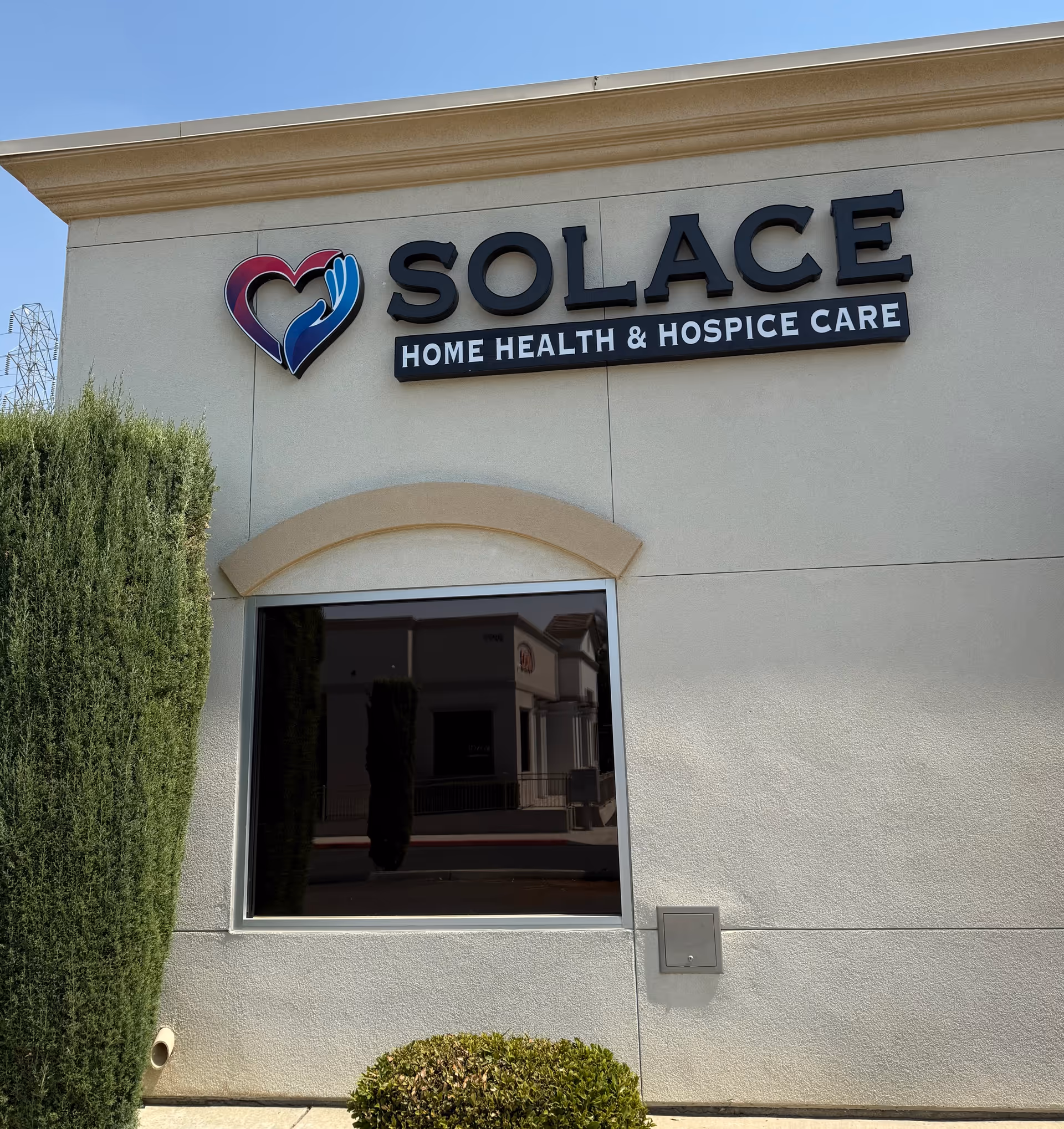 Exterior of SOLACE Healthcare building featuring the SOLACE sign and heart logo.