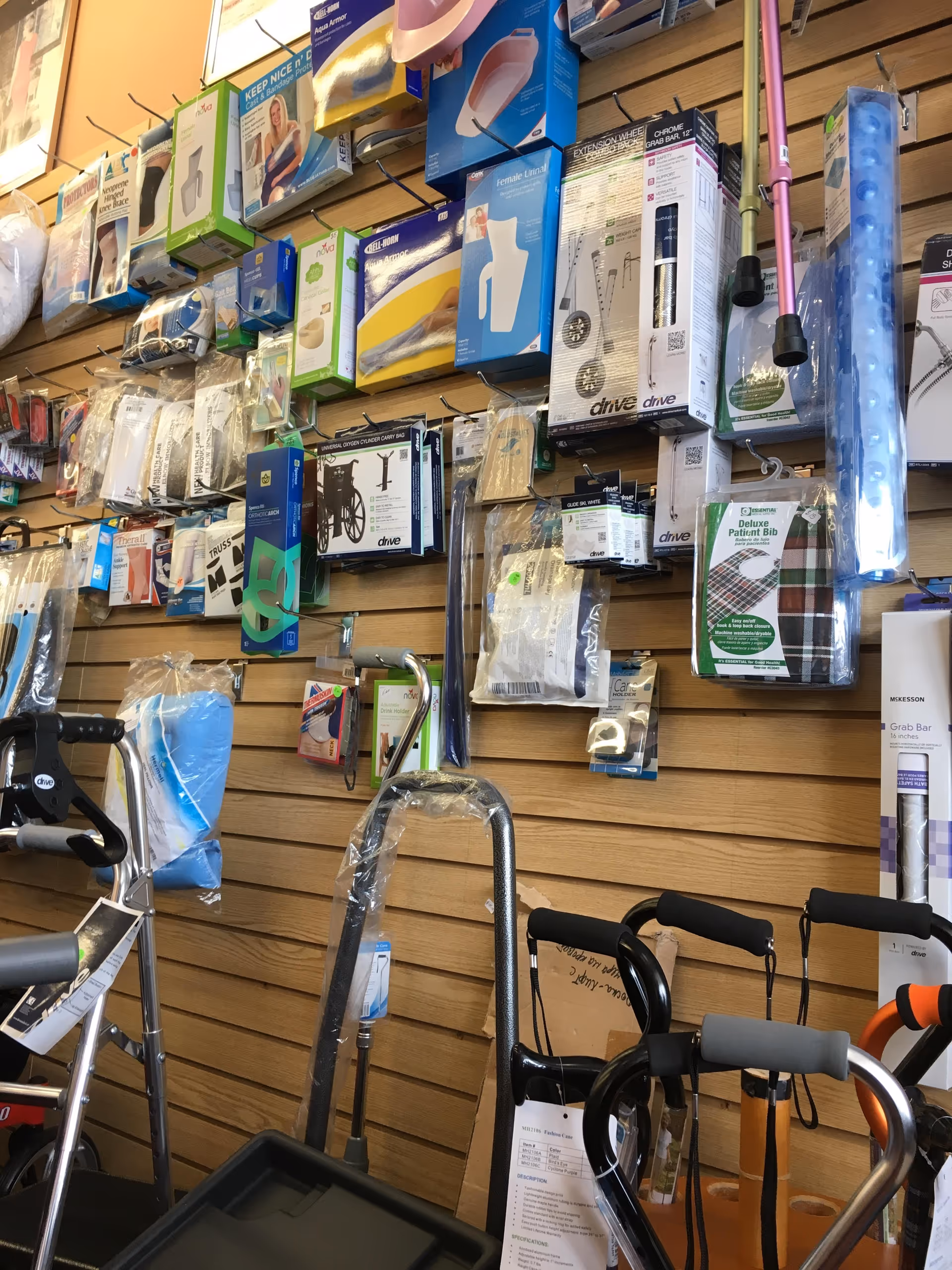 Interior store display of mobility aids and boxed medical supplies on a slatwall.