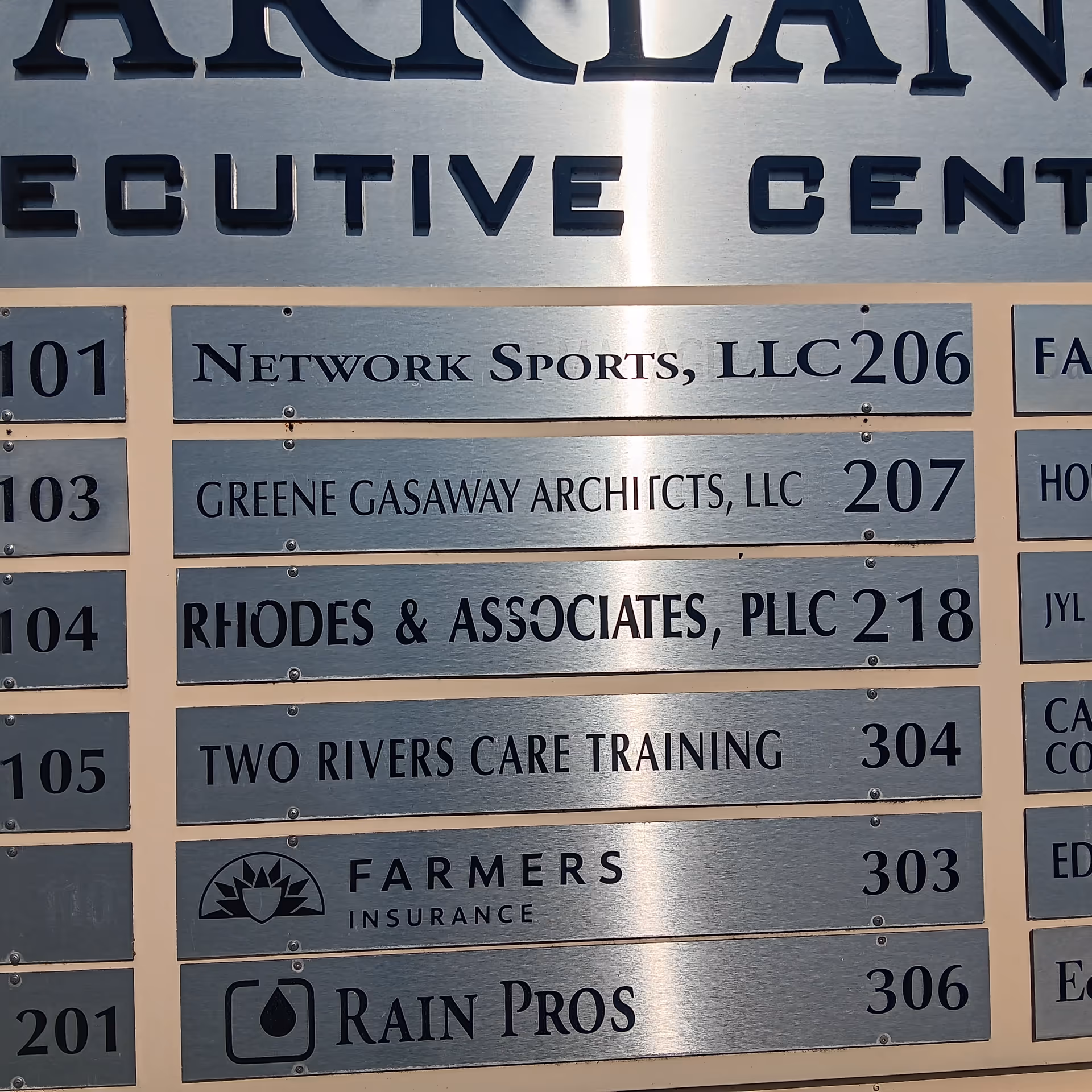 Directory sign listing Two Rivers Care Training among others inside a building.