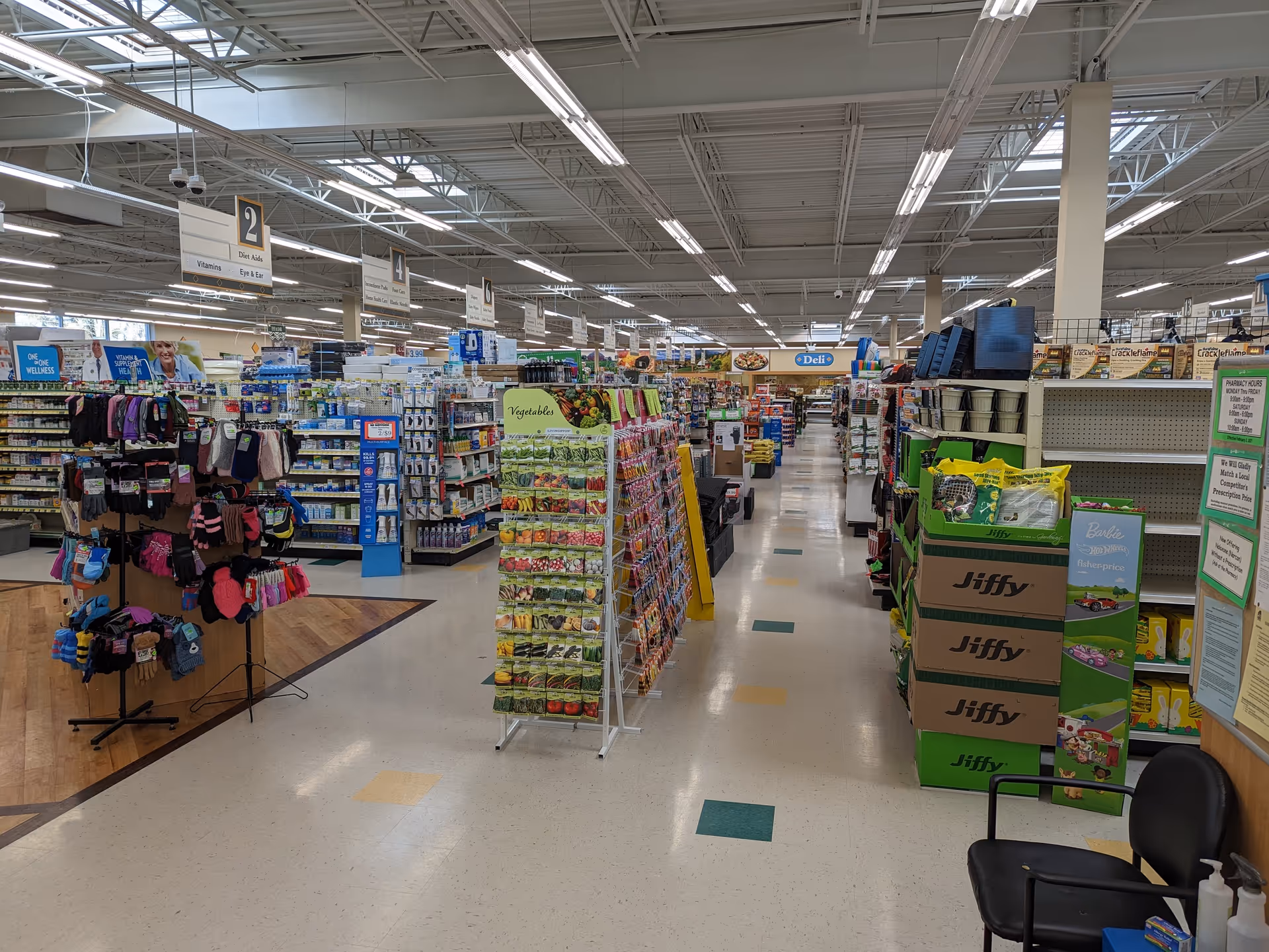 Inside a Discount Drug Mart store, aisles brim with products, displays, and checkout areas.