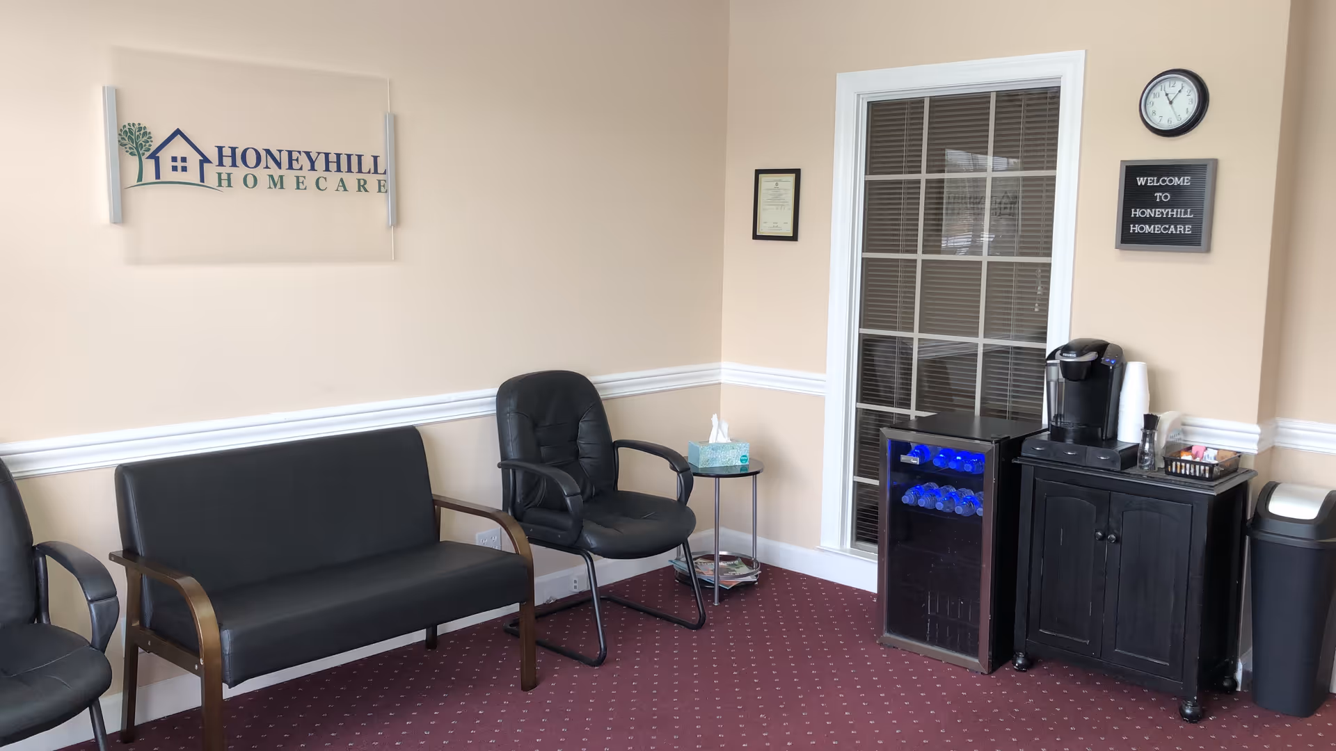 Reception area at HoneyHill HomeCare with seating and a coffee station.