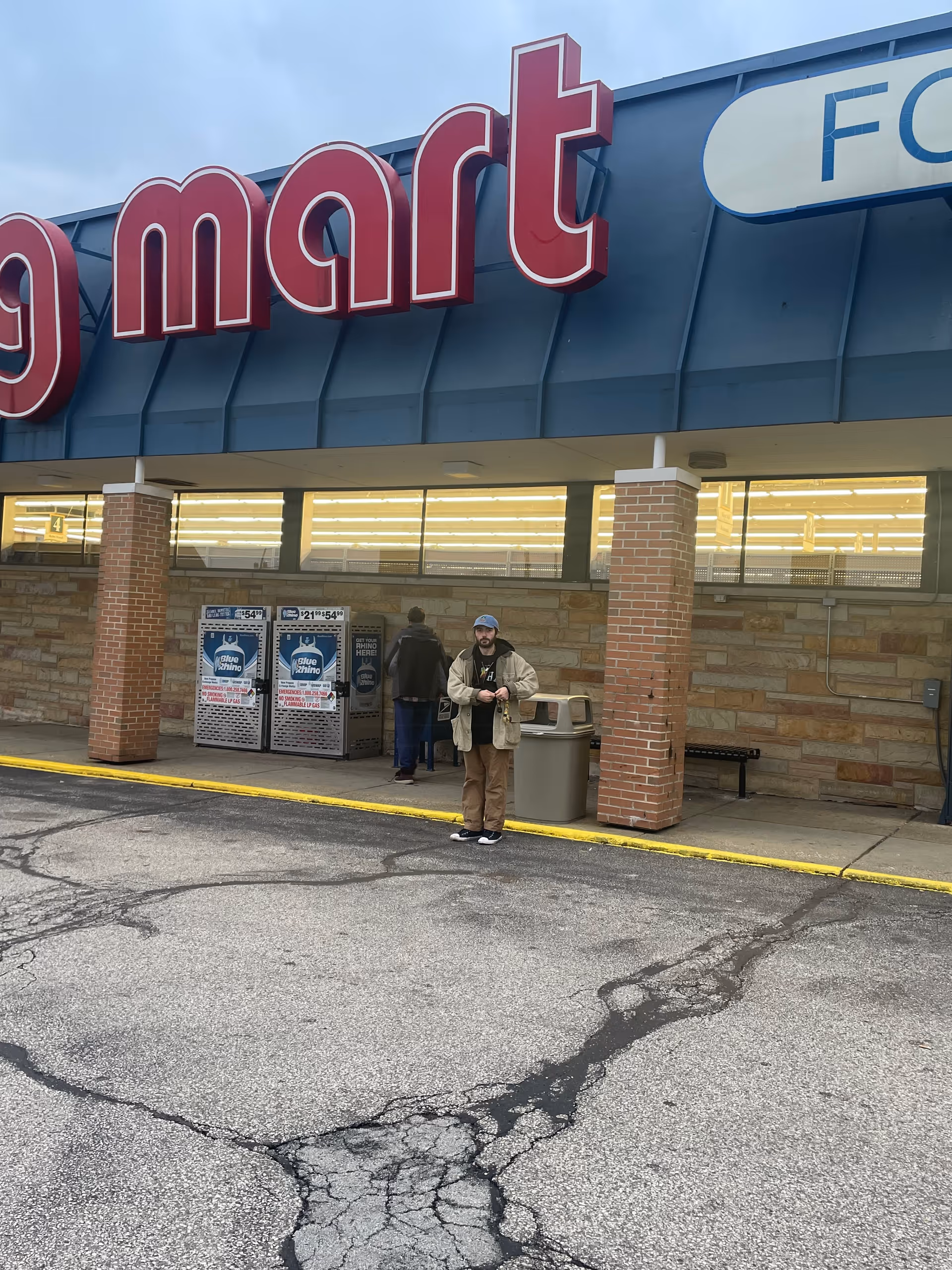 Exterior view of Discount Drug Mart storefront with a person near the entrance.