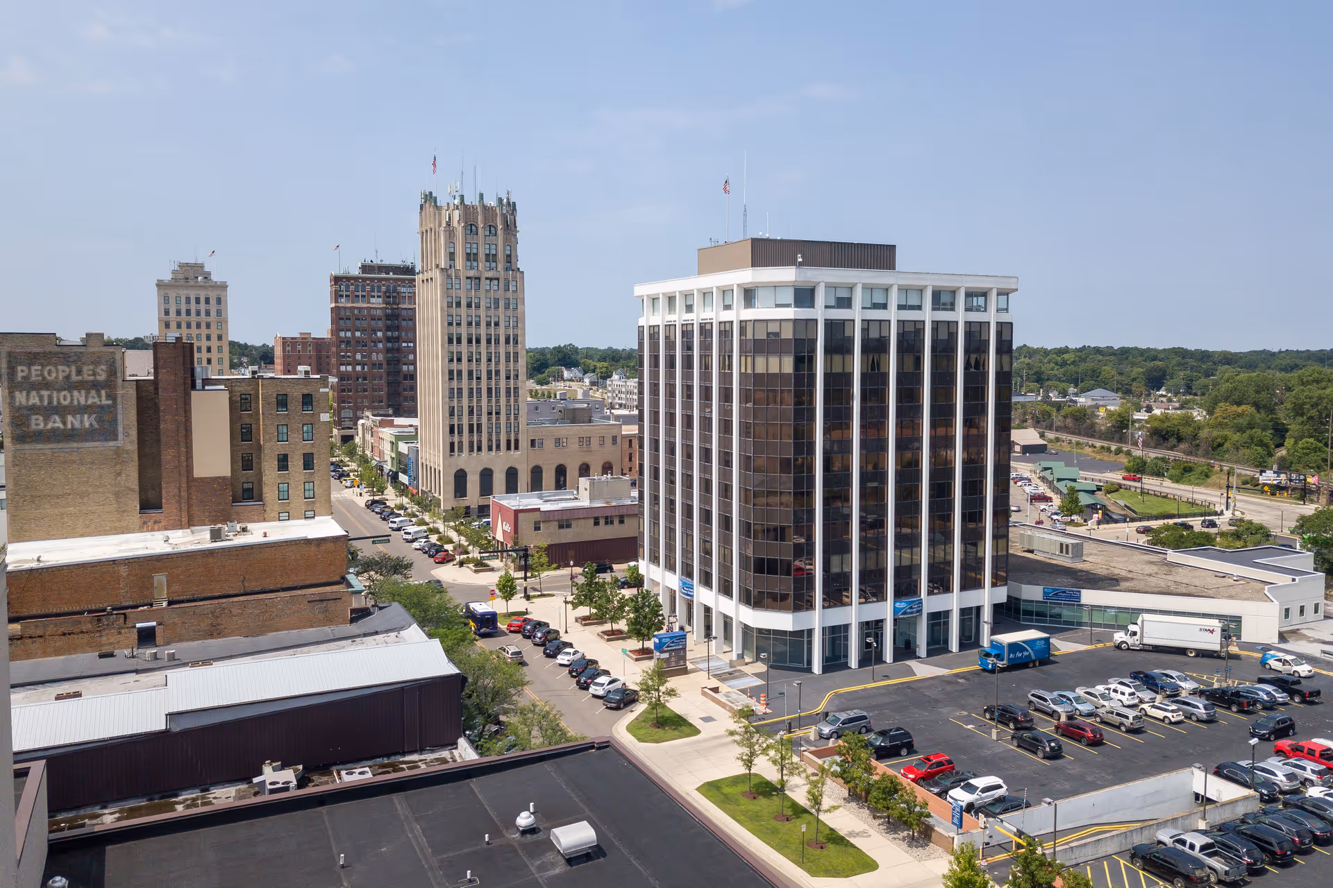 Aerial view of downtown with a tall glass office building and surrounding streets.
