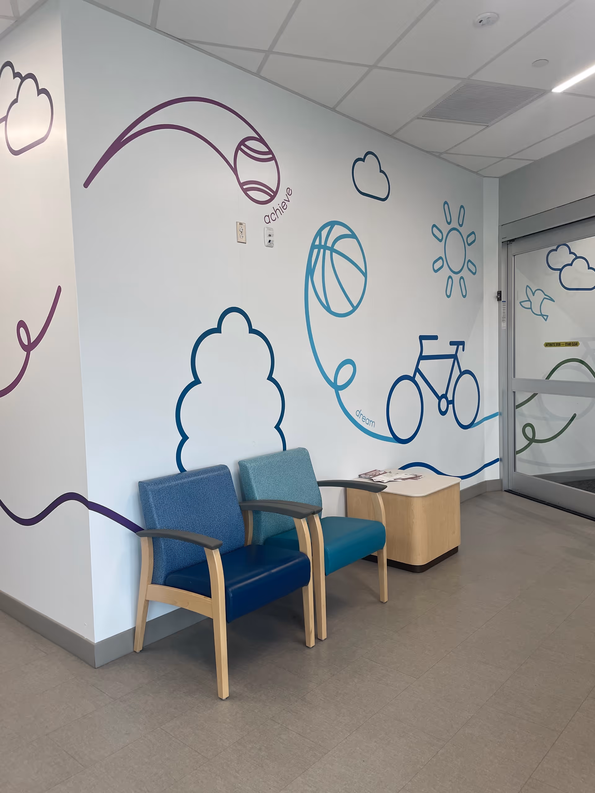 Interior waiting area at BJC Outpatient Center Edwardsville with blue chairs and mural