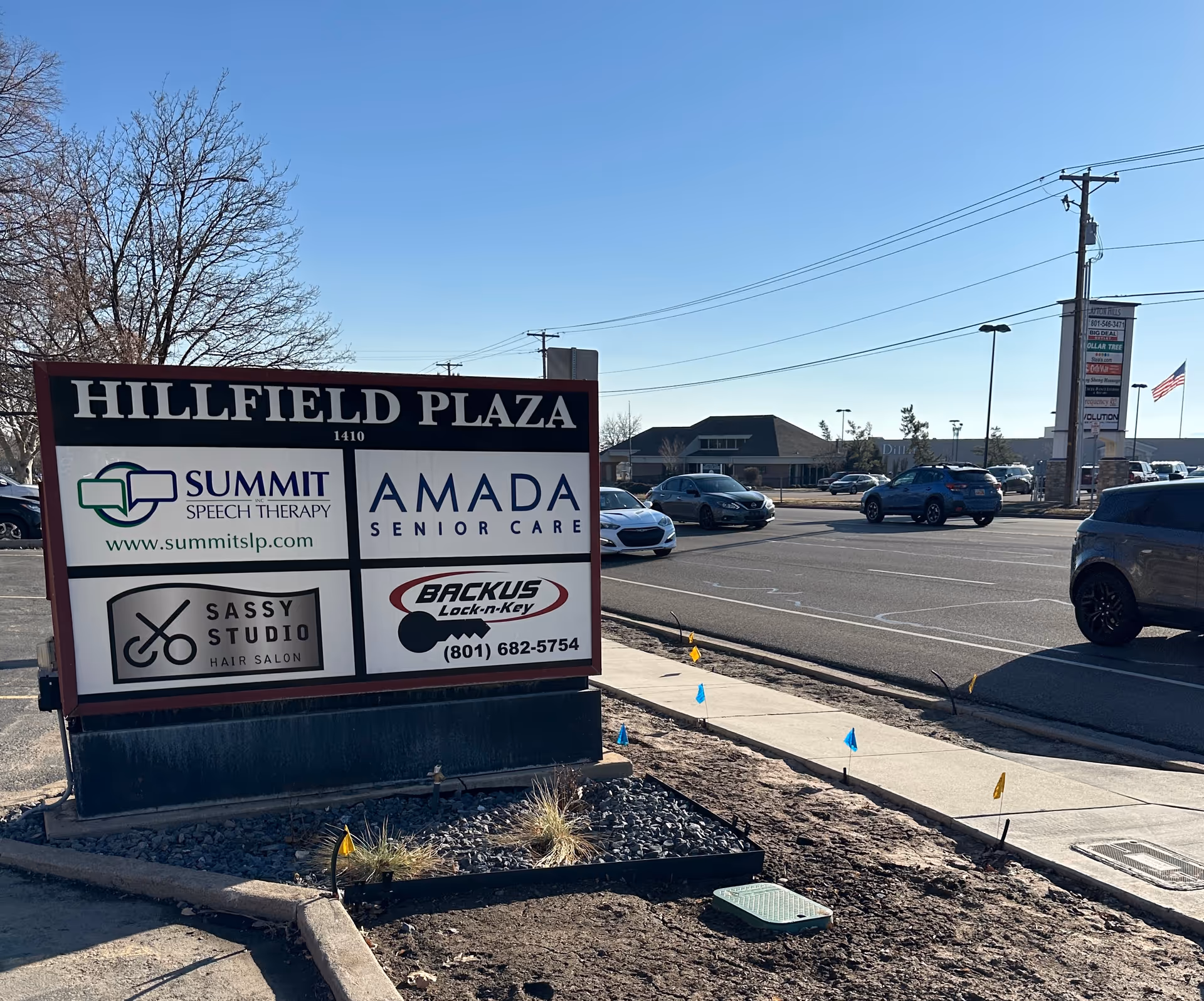 A large outdoor sign reads Hillfield Plaza with Amada Senior Care in a parking lot.