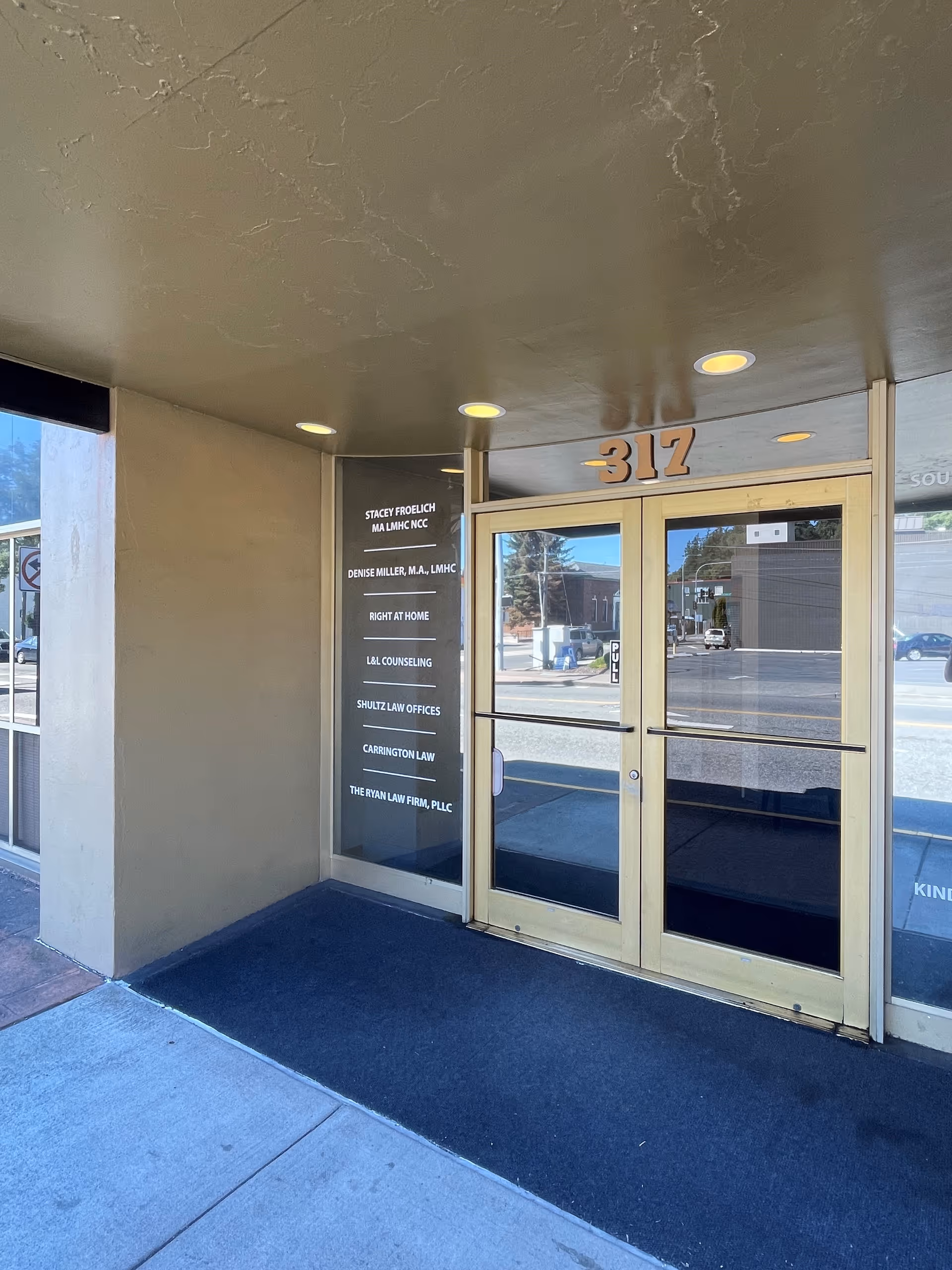 Exterior storefront with gold-framed glass doors and the address number 317.
