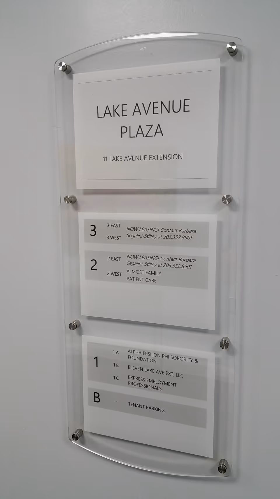 Interior directory plaque at Lake Avenue Plaza showing floor listings and tenant information.