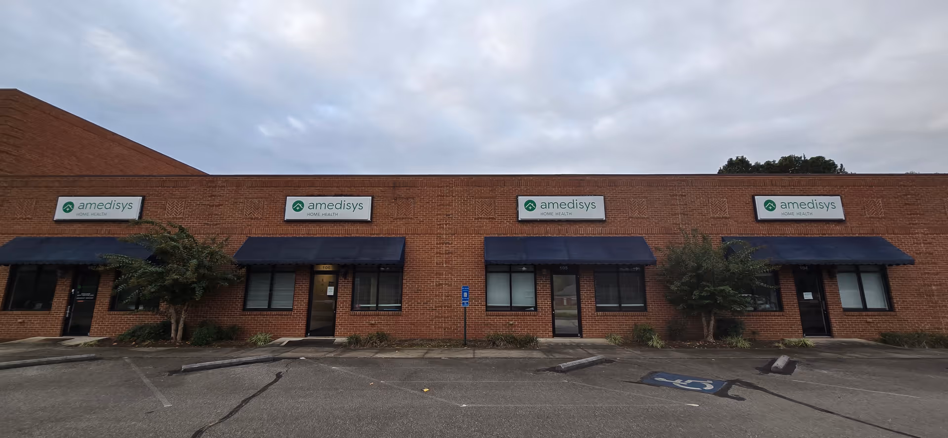 Exterior view of a brick building with Amedisys Home Health signs and awnings