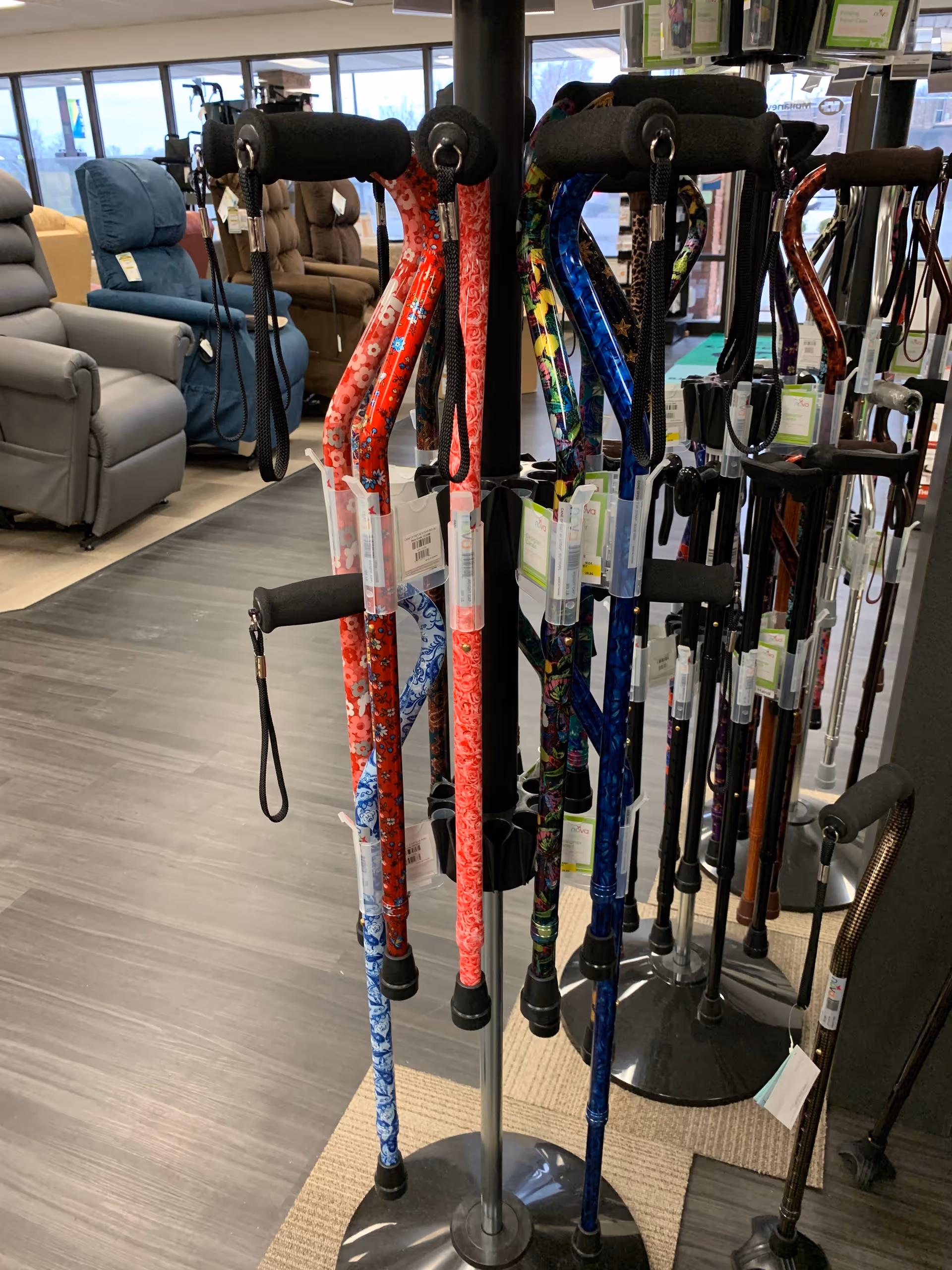 Indoor showroom at a senior living facility displaying colorful canes on stands.