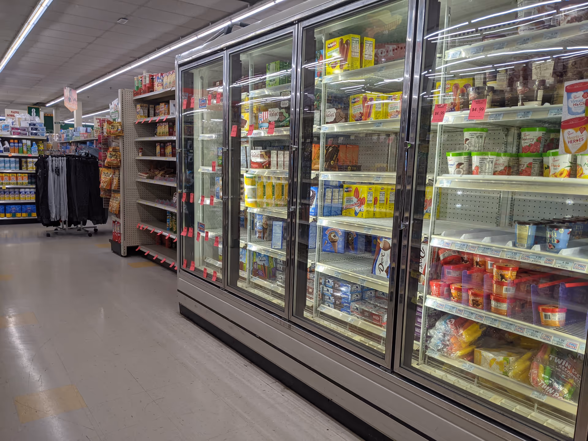 Discount Drug Mart interior with glass-front refrigerators and aisle shelving.