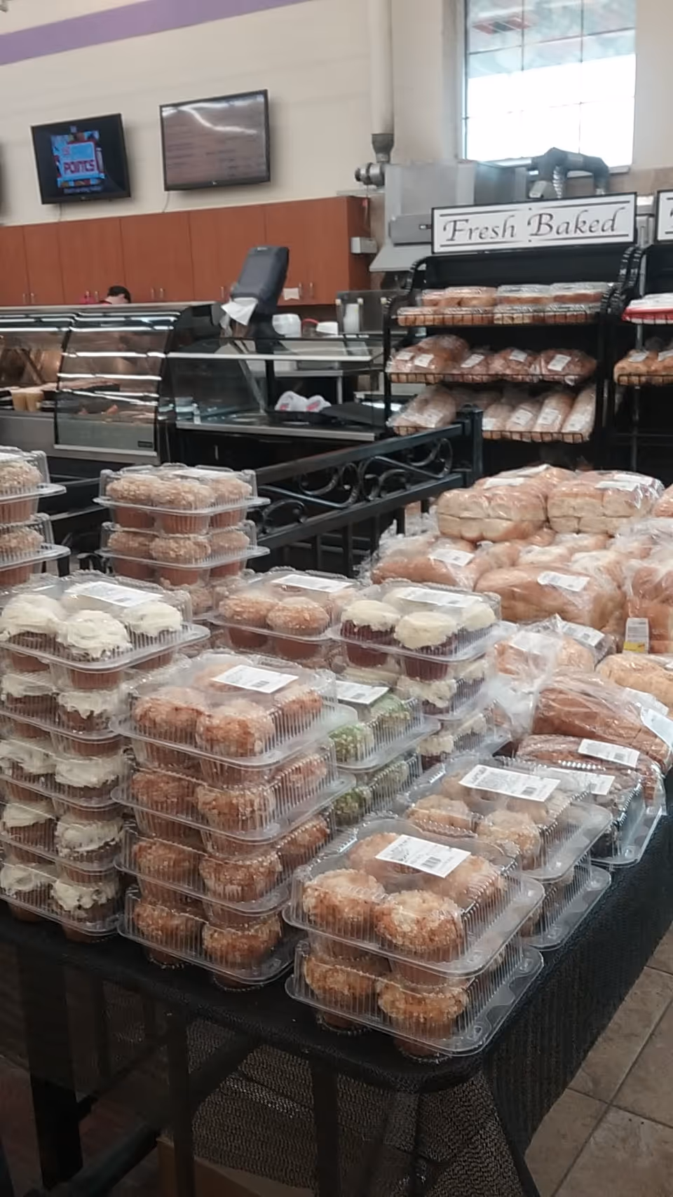 Inside a Discount Drug Mart bakery counter with assorted pastries, breads, and fresh baked goods.