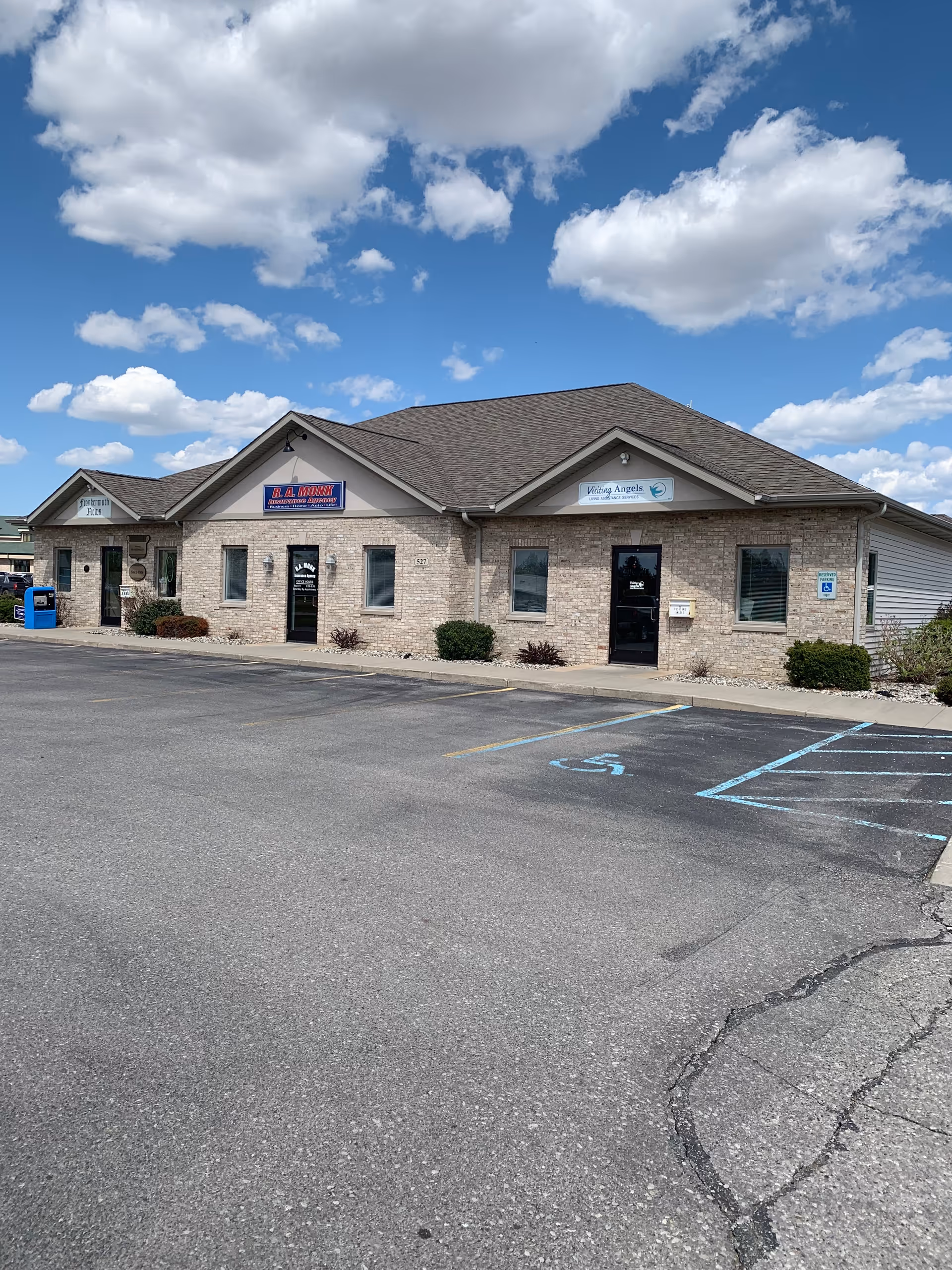 Single-story brick building with Visiting Angels Senior Home Care signage, parking lot in front.