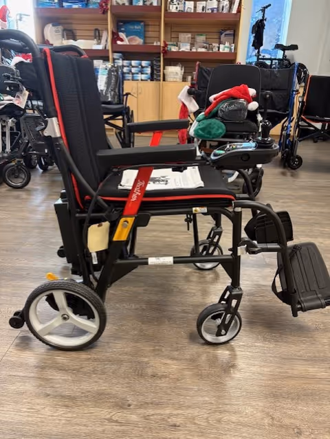 Indoor showroom displaying wheelchairs and medical supplies on shelves.
