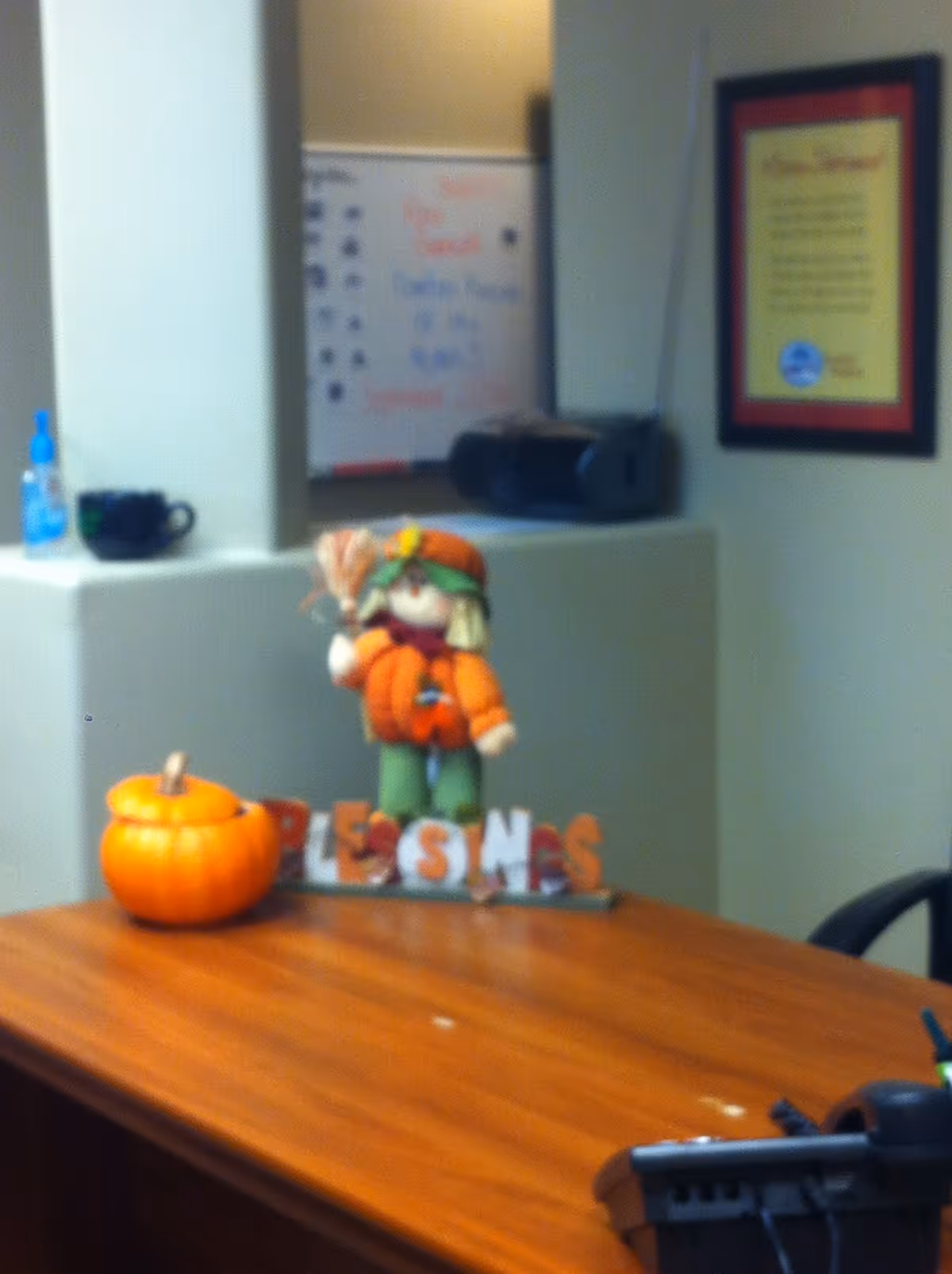 Interior office desk with pumpkins and fall decor in a facility.