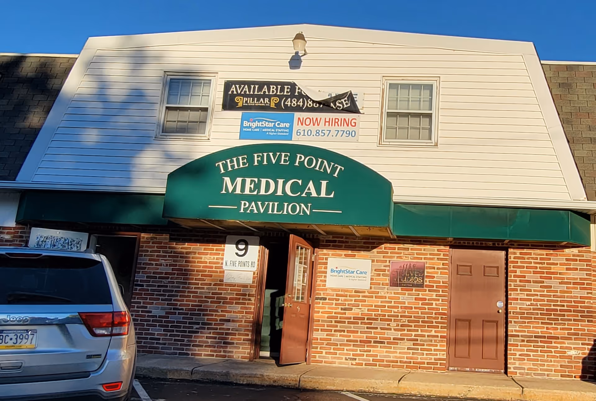 Exterior view of The Five Point Medical Pavilion with BrightStar Care banners.