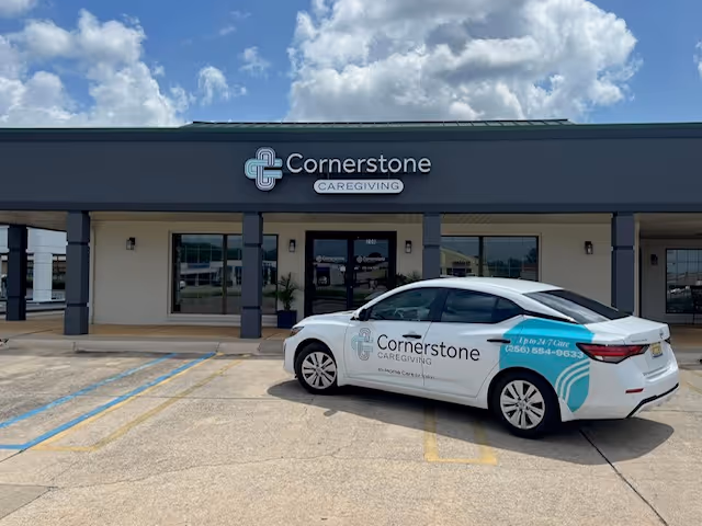 Exterior view of Cornerstone Caregiving storefront with a branded car in the parking lot