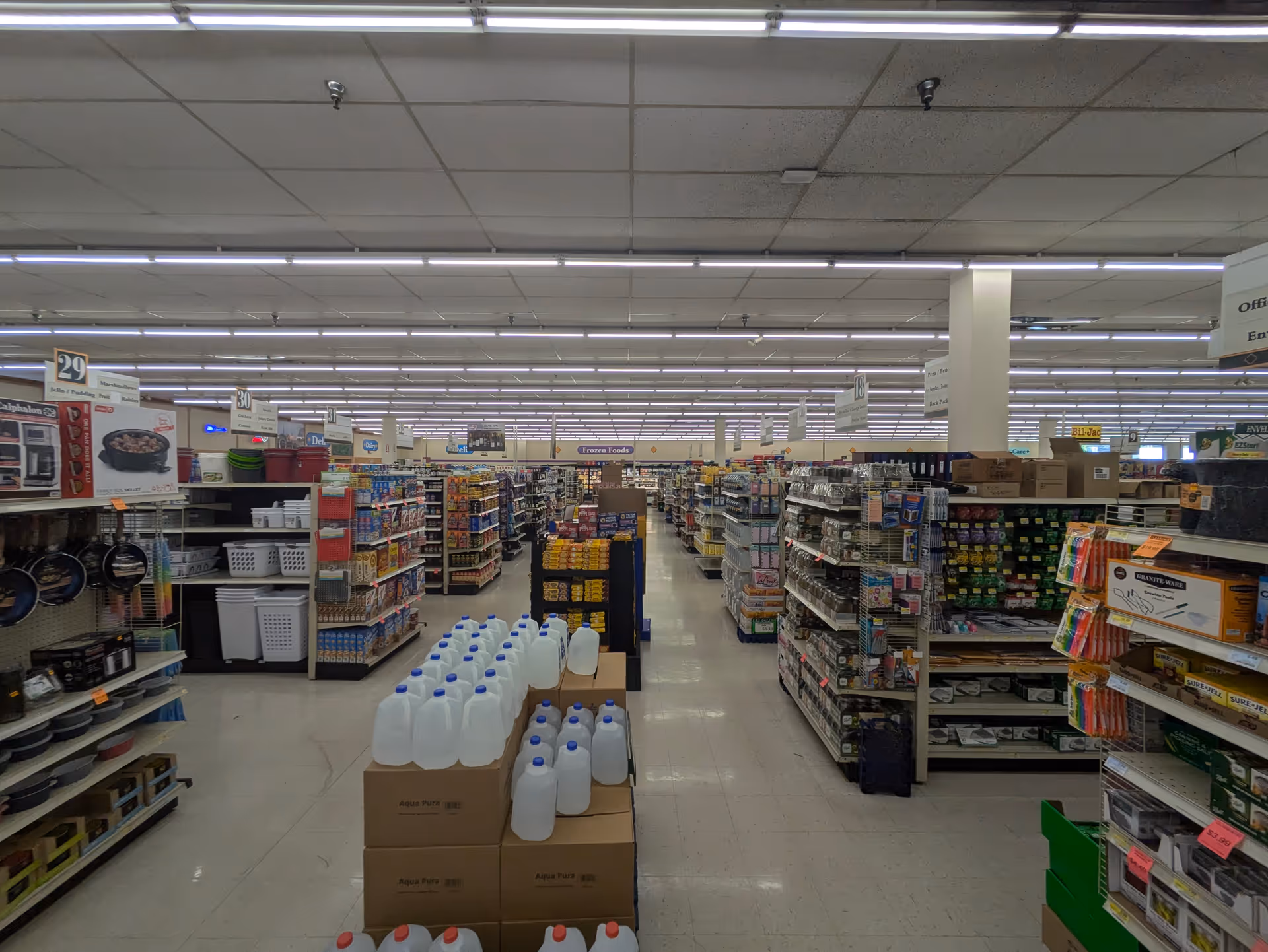 Wide view of Discount Drug Mart interior with aisles, shelves, and products.