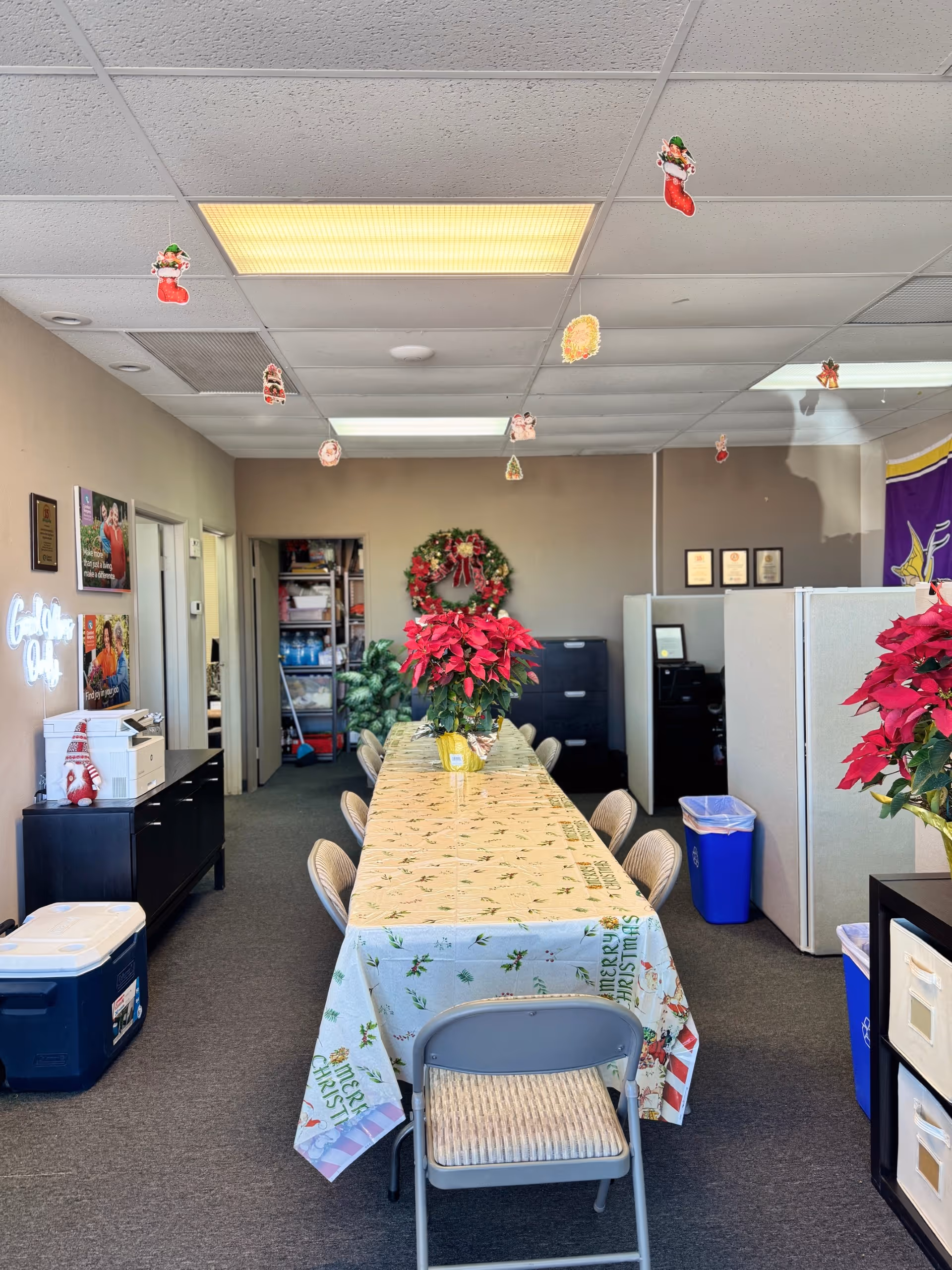 Long communal dining table with Christmas decorations in a senior living dining room.