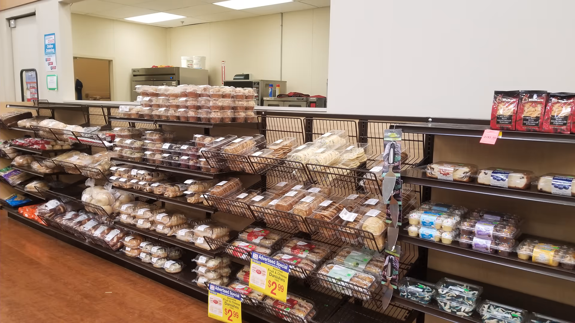 Interior of Discount Drug Mart bakery with bread and pastries on shelves.