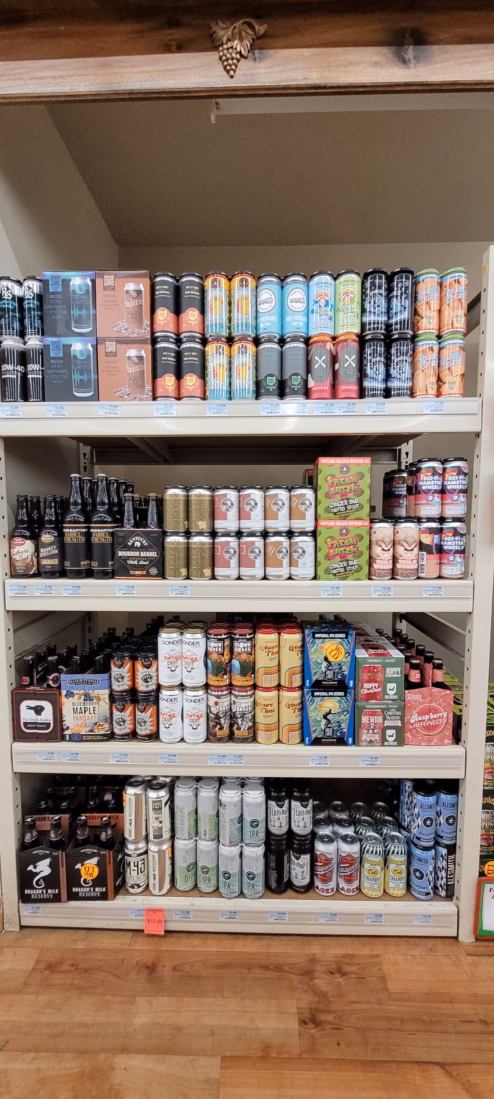 Interior store shelf displaying assorted beers and beverages at Discount Drug Mart.