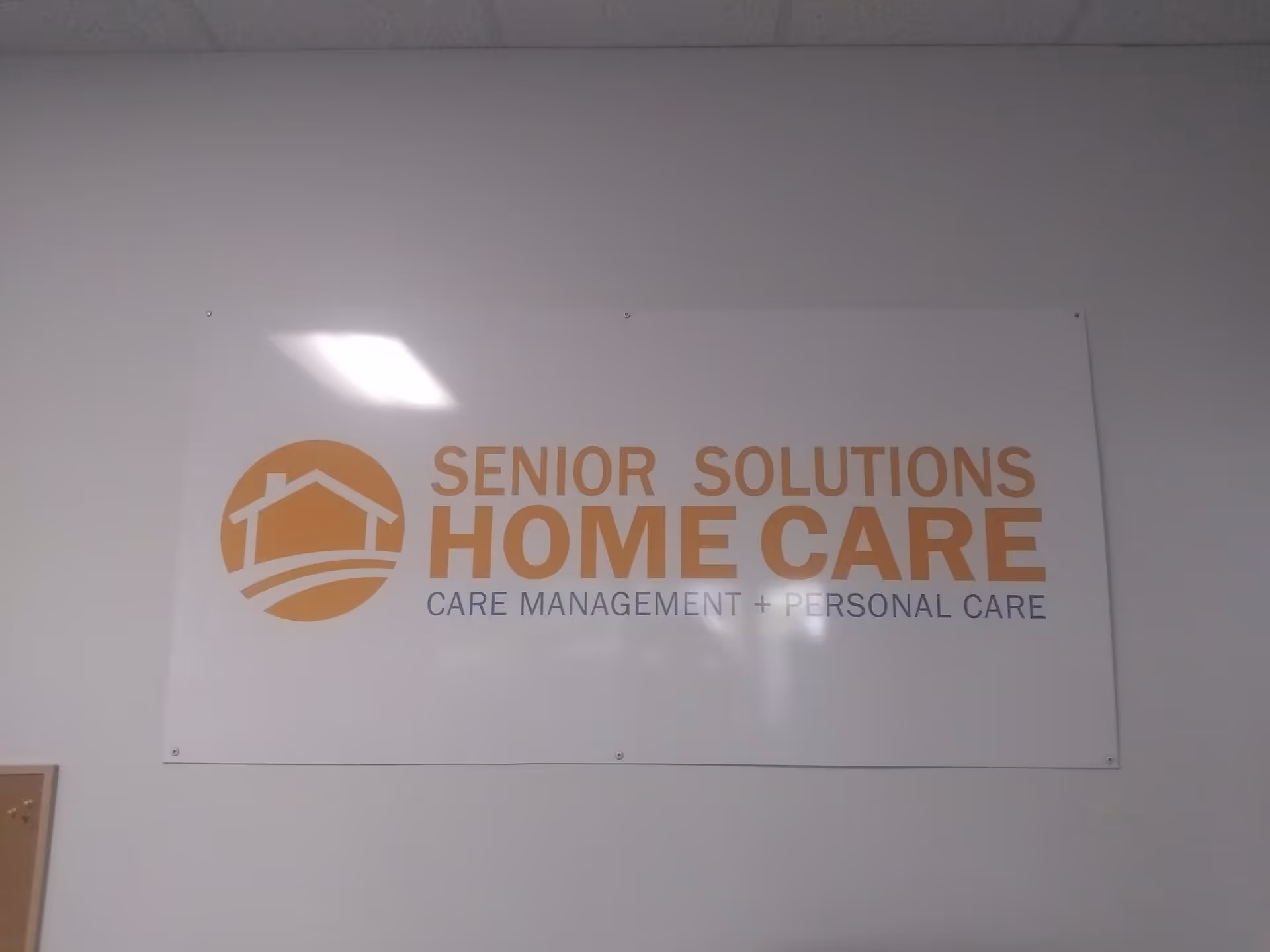 A wall-mounted sign reading 'Senior Solutions Home Care' with a circular logo