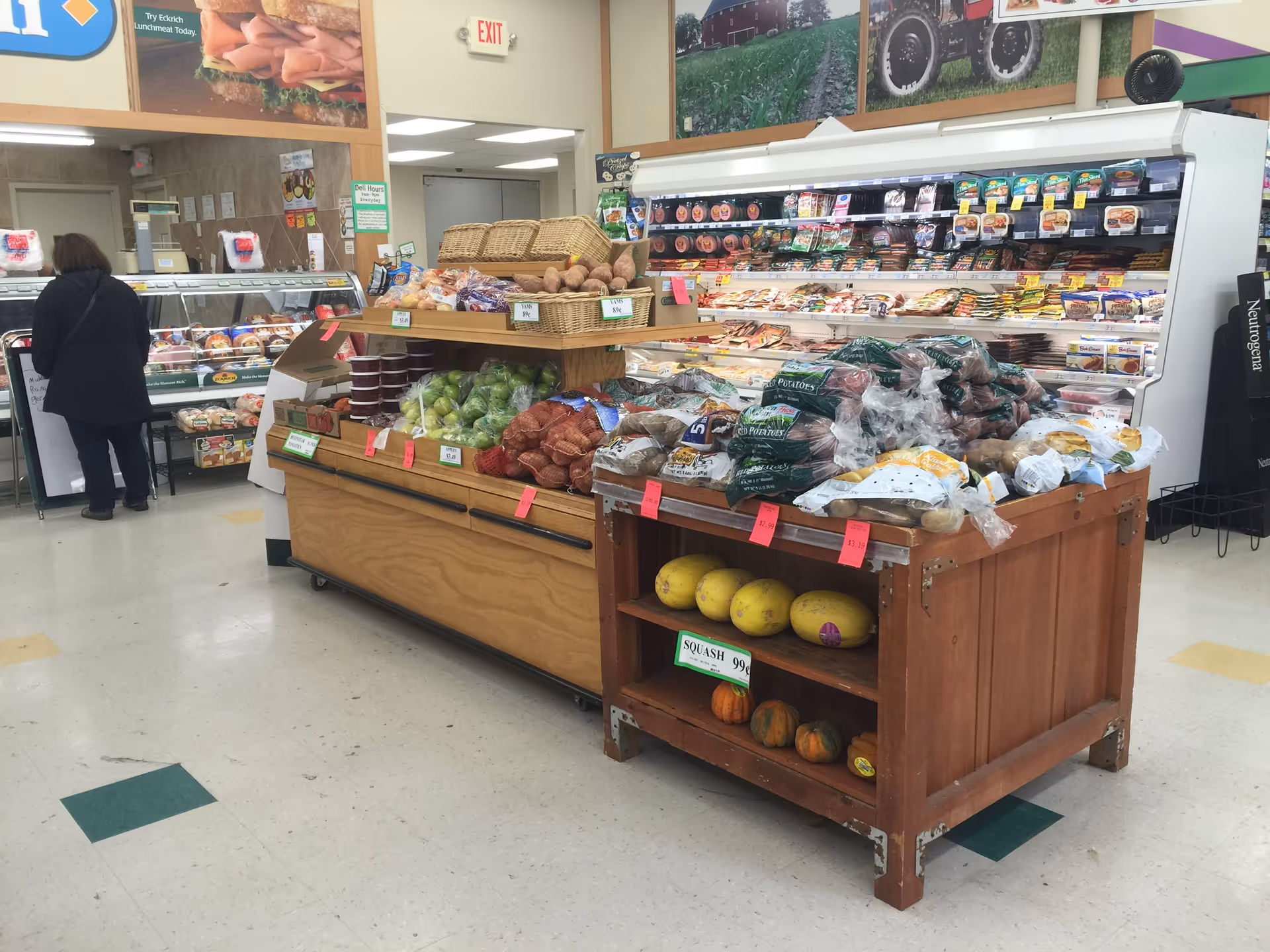 Inside a Discount Drug Mart store interior with produce displays and shoppers.