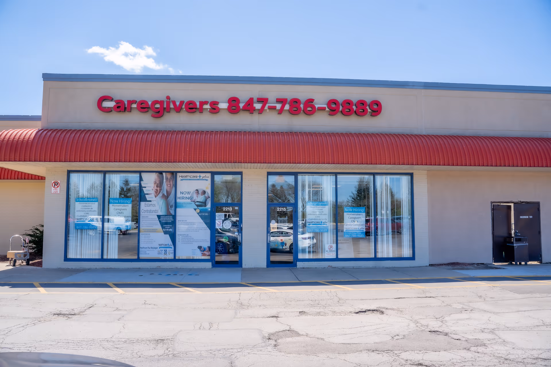 Front of a storefront with a red awning and Caregivers 847-786-9889 sign