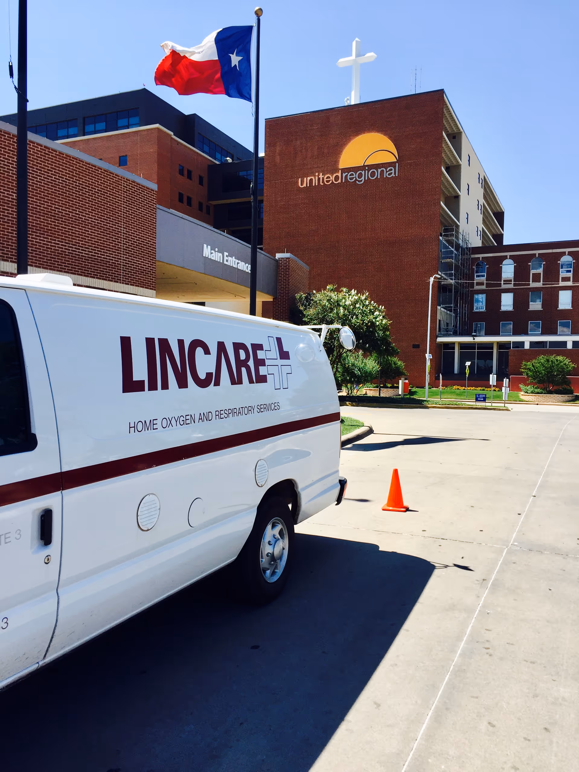 LINCARE van parked outside United Regional building with a Texas flag overhead.