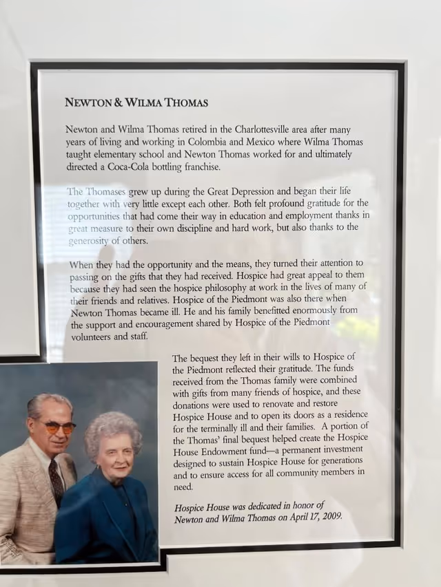 Framed wall plaque with a photo of an elderly couple in the bottom left.